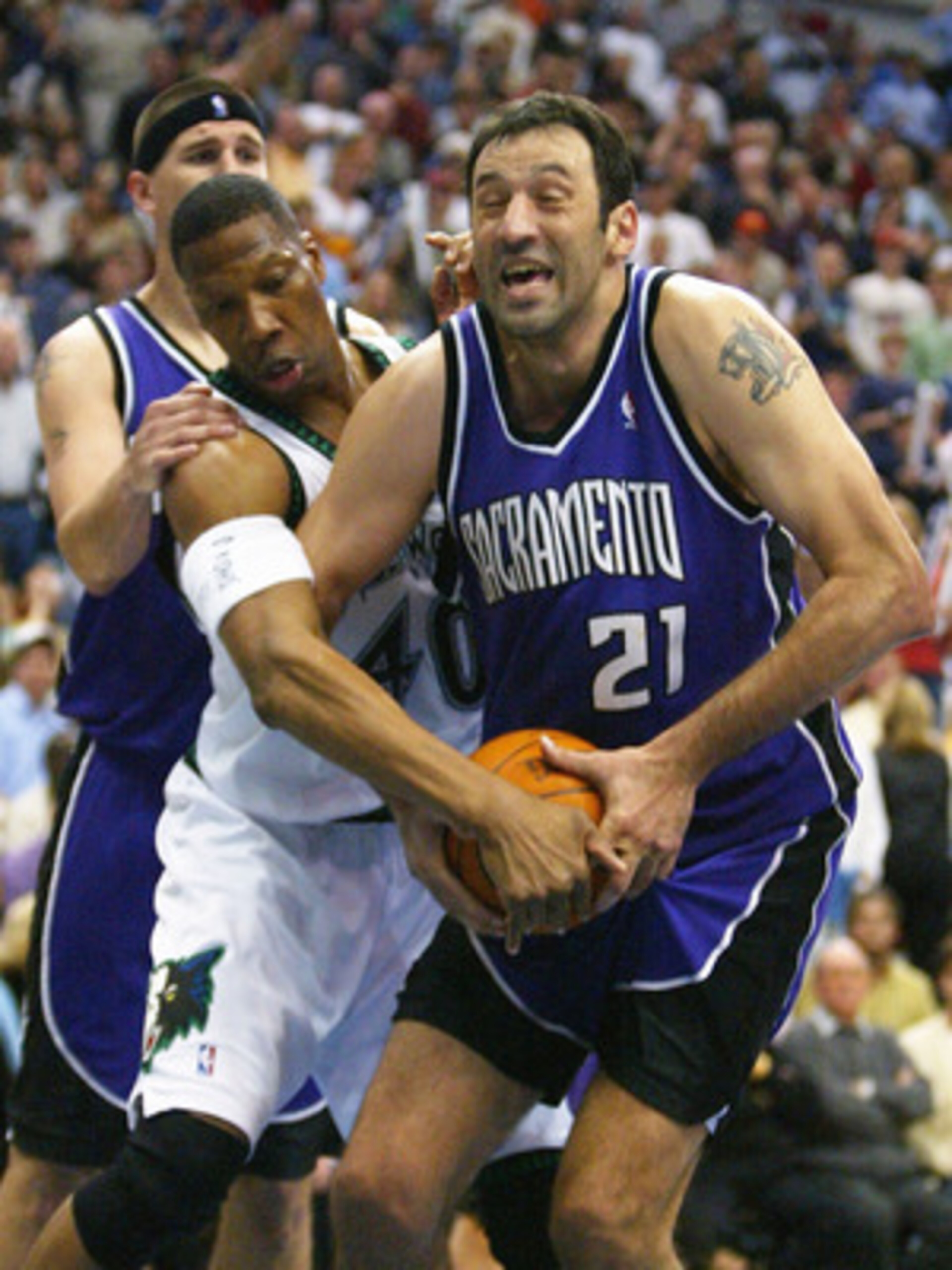 MINNEAPOLIS - MAY 14: Vlade Divac #21 of the Sacramento Kings is fouled by Ervin Johnson #40 of the Minnesota Timberwolves in Game five of the Western Conference Semifinals of the 2004 NBA Playoffs on May 14, 2004 at the Target Center in Minneapolis, M MINNEAPOLIS - MAY 14: Vlade Divac #21 of the Sacramento Kings is fouled by Ervin Johnson #40 of the Minnesota Timberwolves in Game five of the Western Conference Semifinals of the 2004 NBA Playoffs on May 14, 2004 at the Target Center in Minneapolis, M