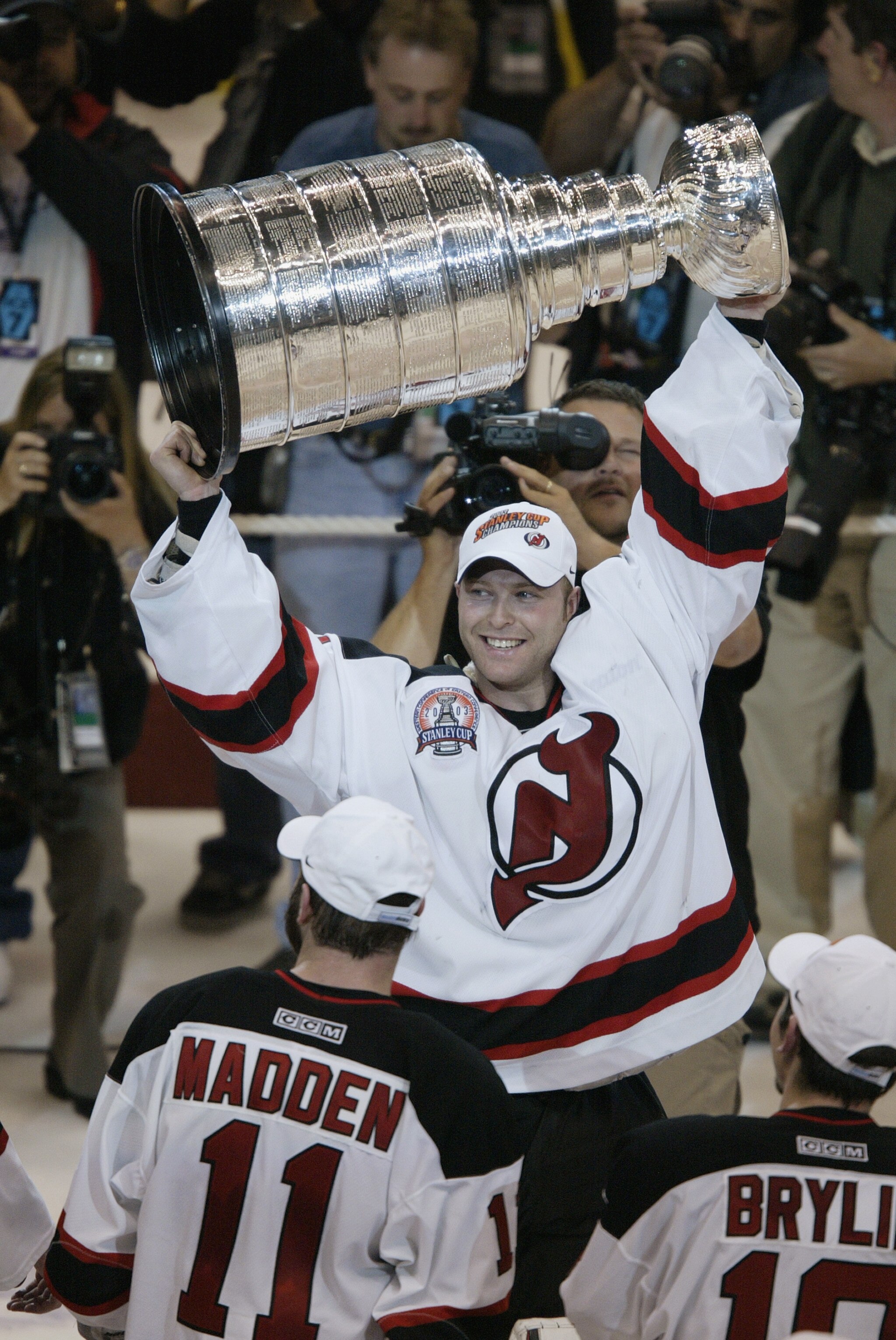 EAST RUTHERFORD, NJ - JUNE 9:  Goalie Martin Brodeur #30 holds up the Stanley Cup trophy after defeating the Mighty Ducks of Anaheim 3-0 in game seven of the 2003 Stanley Cup Finals at Continental Airlines Arena on June 9, 2003 in East Rutherford, New Jer