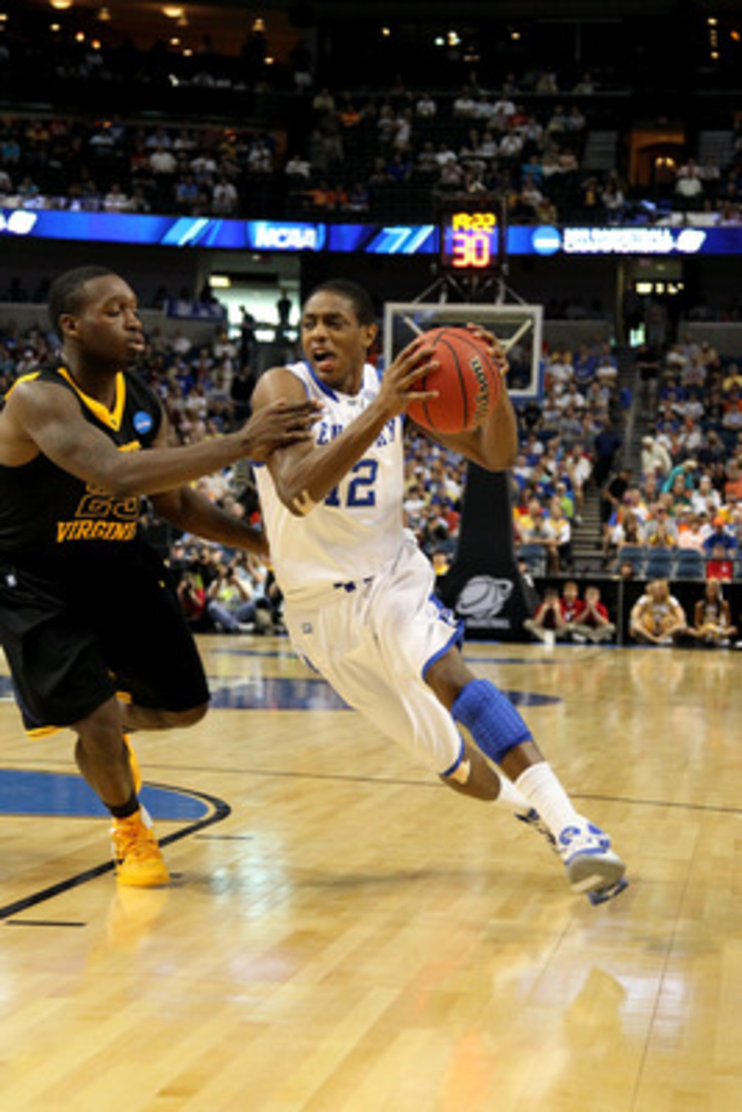 TAMPA, FL - MARCH 19:  Brandon Knight #12 of the Kentucky Wildcats drives against Darryl Bryant #25 of the West Virginia Mountaineers during the third round of the 2011 NCAA men's basketball tournament at St. Pete Times Forum on March 19, 2011 in Tampa, F