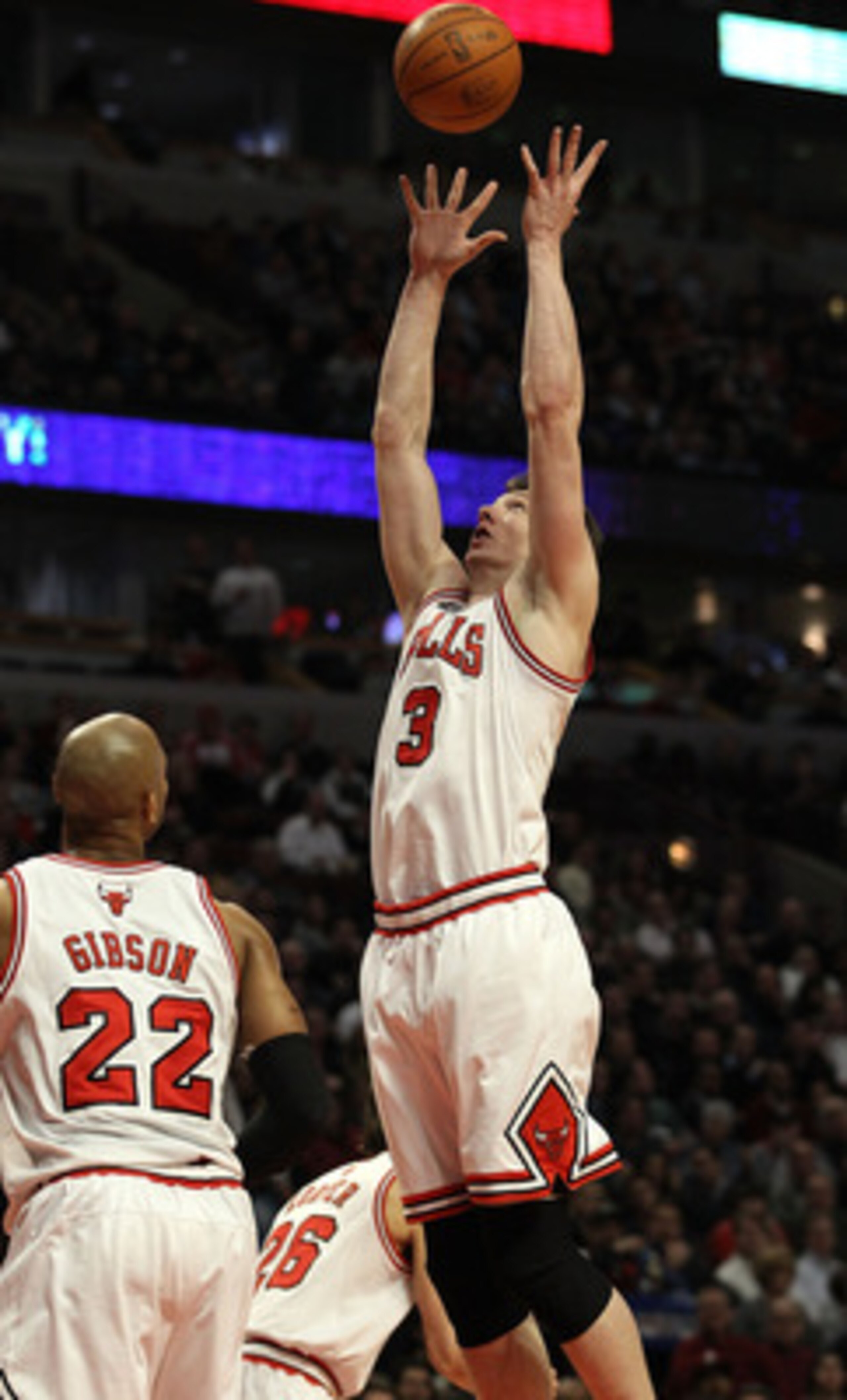 CHICAGO, IL - MARCH 07: Omer Asik #3 of the Chicago Bulls grabs a rebound over teammate Taj Gibson #22 against the New Orleans Hornets at the United Center on March 7, 2011 in Chicago, Illinois. The Bulls defeated the Hornets 85-77. NOTE TO USER: User exp