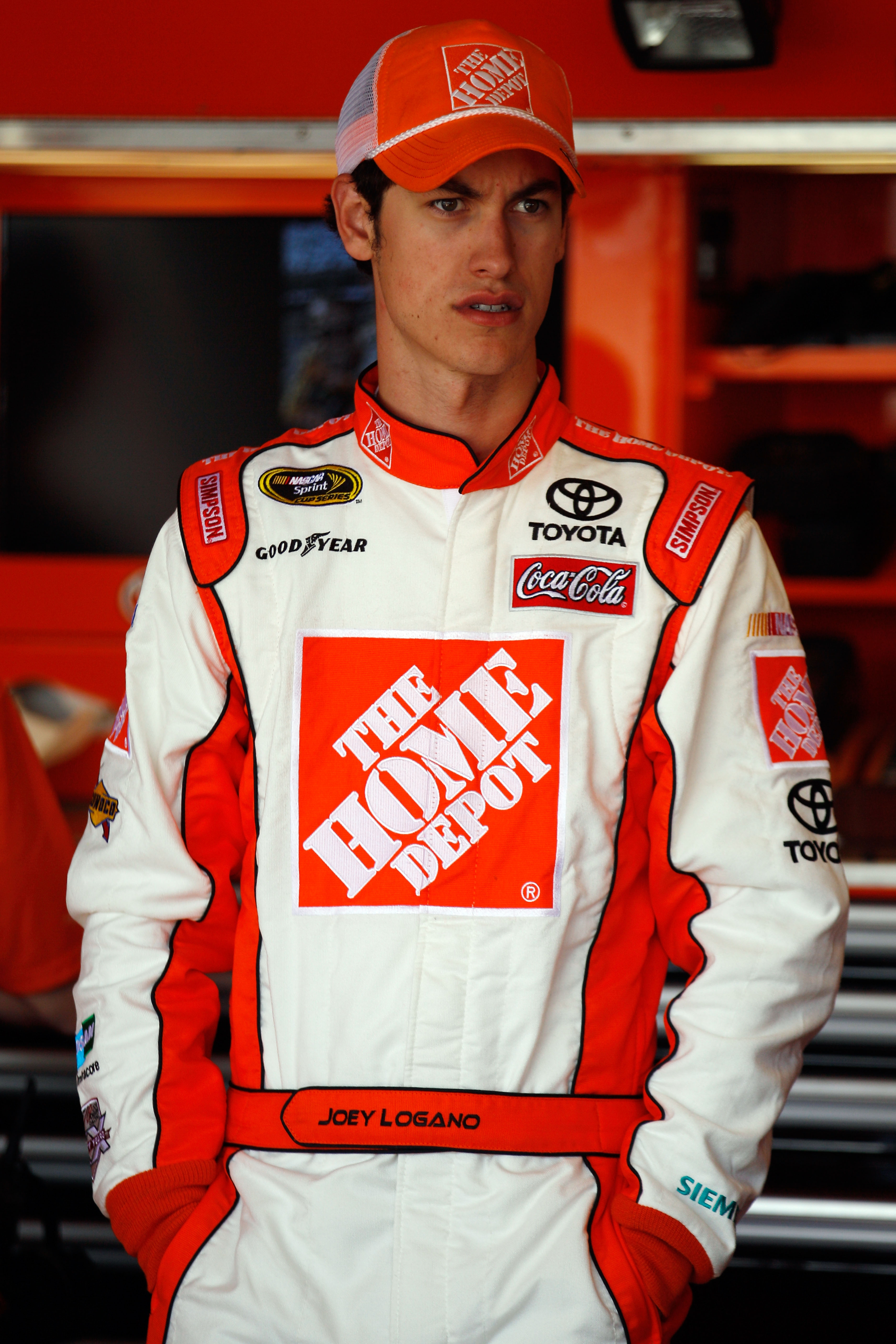 RICHMOND, VA - APRIL 29:  Joey Logano, driver of the #20 The Home Depot Toyota, stands in the garage area during practice for the NASCAR Sprint Cup Series Crown Royal Presents The Matthew & Daniel Hansen 400 at Richmond International Raceway on April 29,