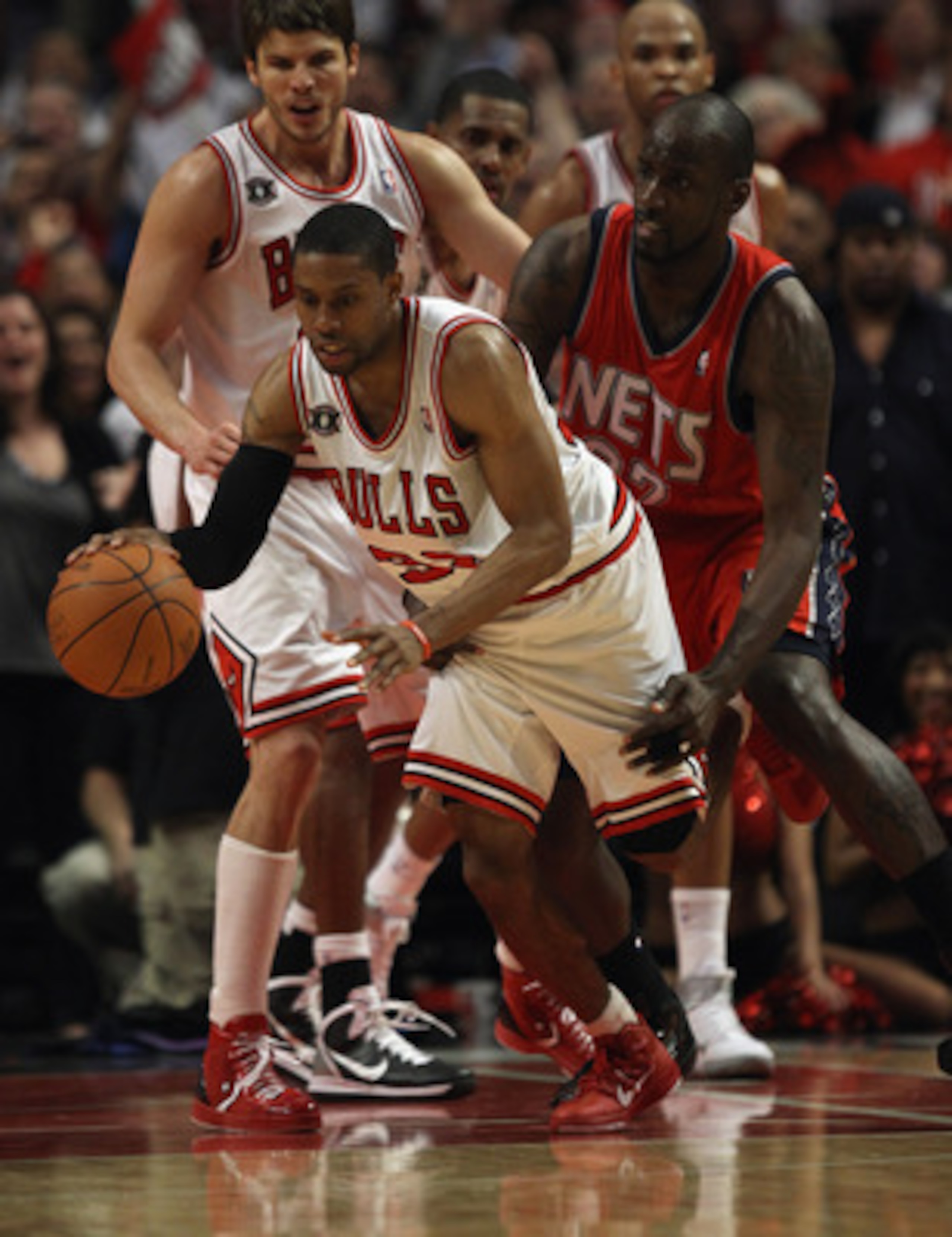 CHICAGO, IL - APRIL 13: C.J. Watson #32 of the Chicago Bulls is fouled in the final minute by Johan Petro #27 of the New Jersey Nets at the United Center on April 13, 2011 in Chicago, Illinois. The Bulls defeated the Nets 97-92. NOTE TO USER: User express