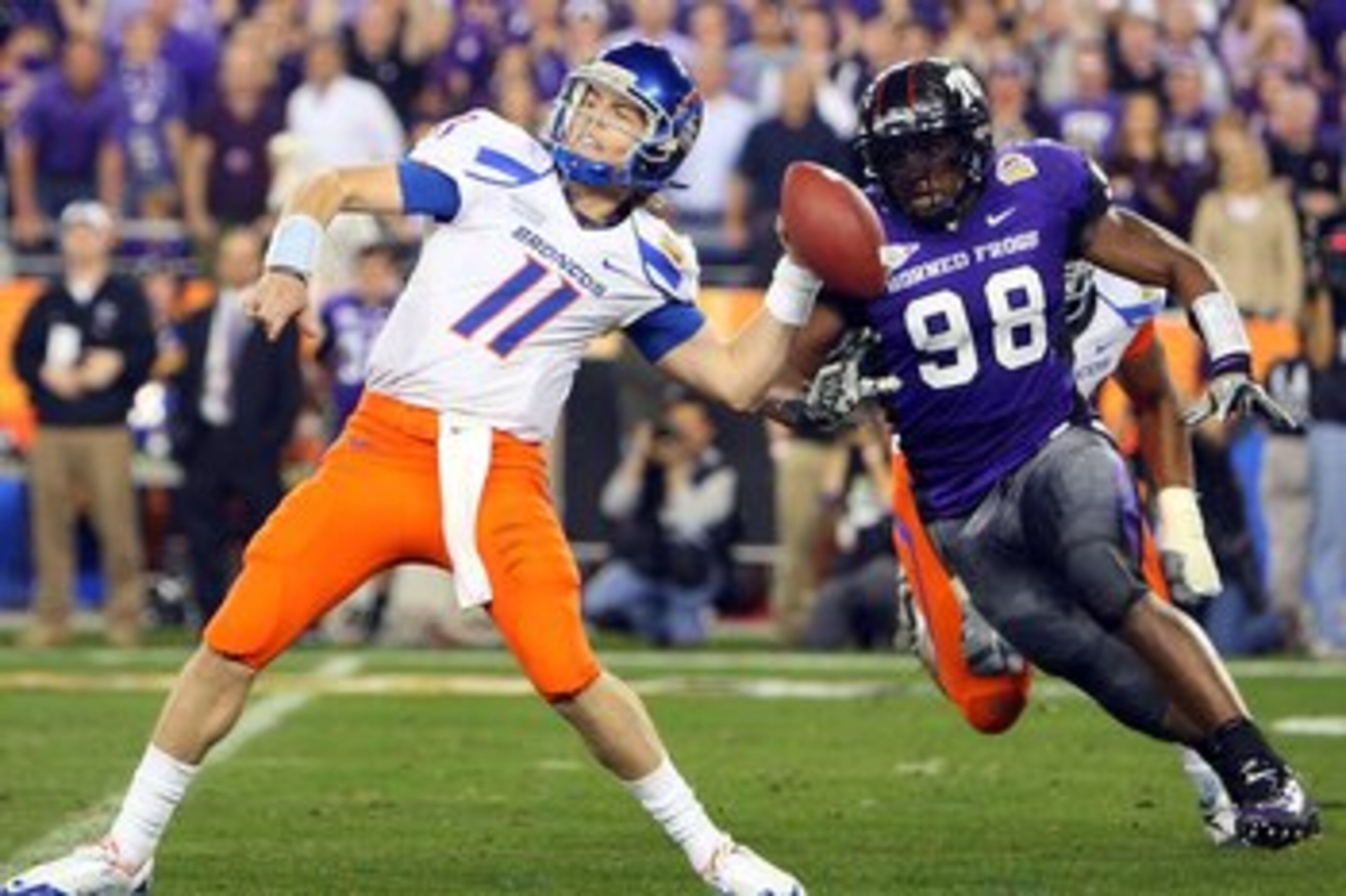 GLENDALE, AZ - JANUARY 04:  Quarterback Kellen Moore #11 of the Boise State Broncos passes the ball in the second half as Jerry Hughes #98 of the TCU Horned Frogs rushes in during the Tostitos Fiesta Bowl at the Universtity of Phoenix Stadium on January 4