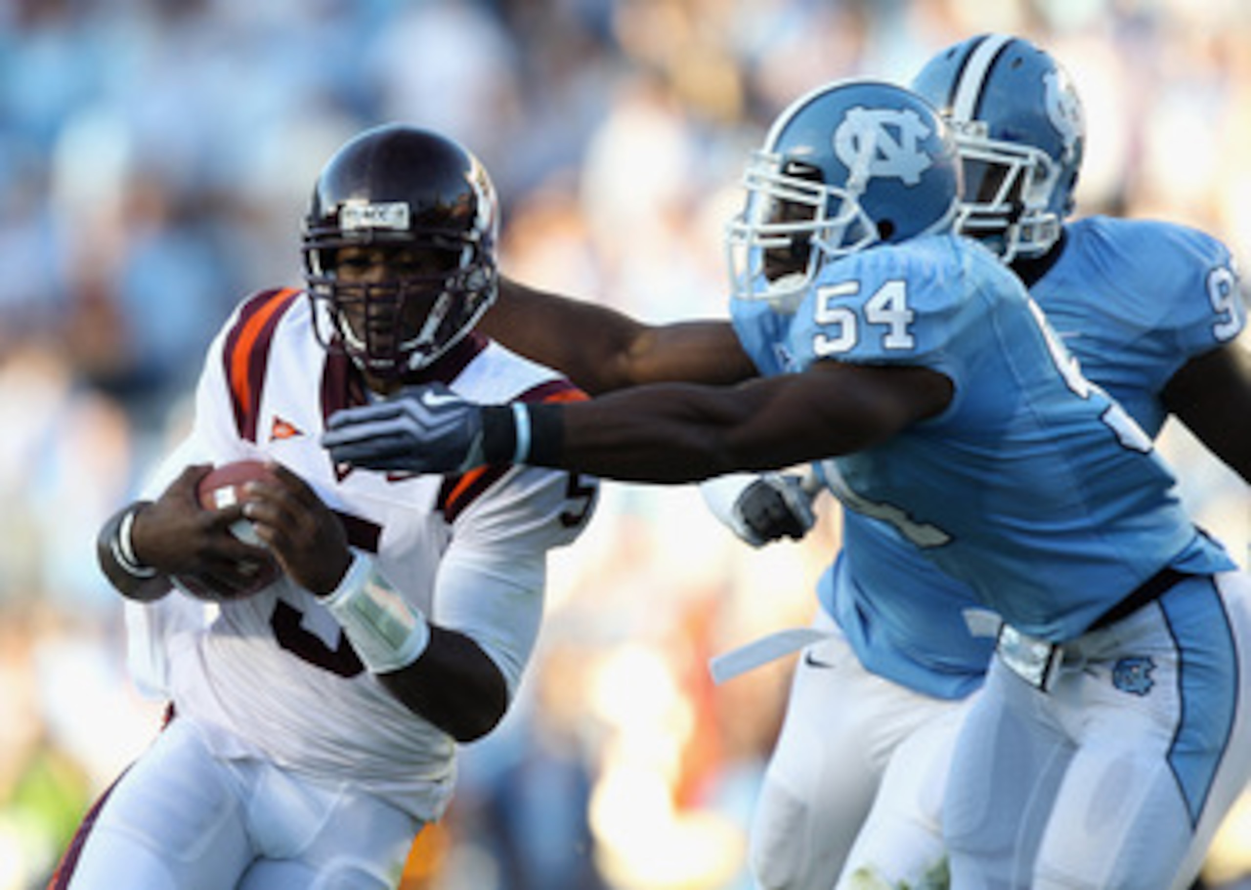 CHAPEL HILL, NC - NOVEMBER 13: Tyrod Taylor #5 of the Virginia Tech Hokies is tackled by Bruce Carter #54 and teammate Jared McAdoo #97 of the North Carolina Tar Heels during their game at Kenan Stadium on November 13, 2010 in Chapel Hill, North Carolina CHAPEL HILL, NC - NOVEMBER 13: Tyrod Taylor #5 of the Virginia Tech Hokies is tackled by Bruce Carter #54 and teammate Jared McAdoo #97 of the North Carolina Tar Heels during their game at Kenan Stadium on November 13, 2010 in Chapel Hill, North Carolina