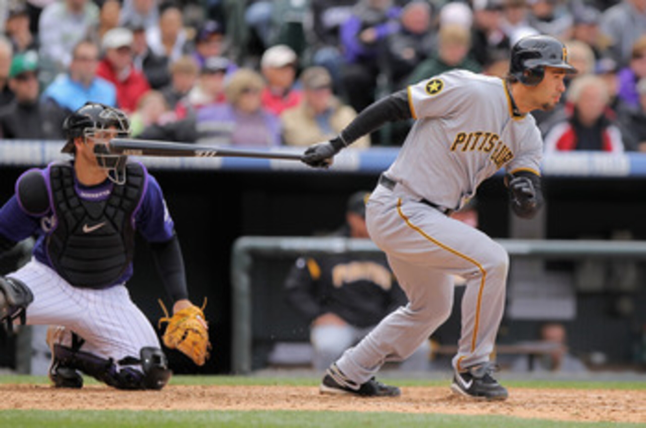 DENVER, CO - MAY 01:  Right fielder Garrett Jones #46 of the Pittsburgh Pirates takes an at bat as catcher Chris Iannetta #20 of the Colorado Rockies backs up the plate at Coors Field on May 1, 2011 in Denver, Colorado. The Pirates defeated the Rockies 8-