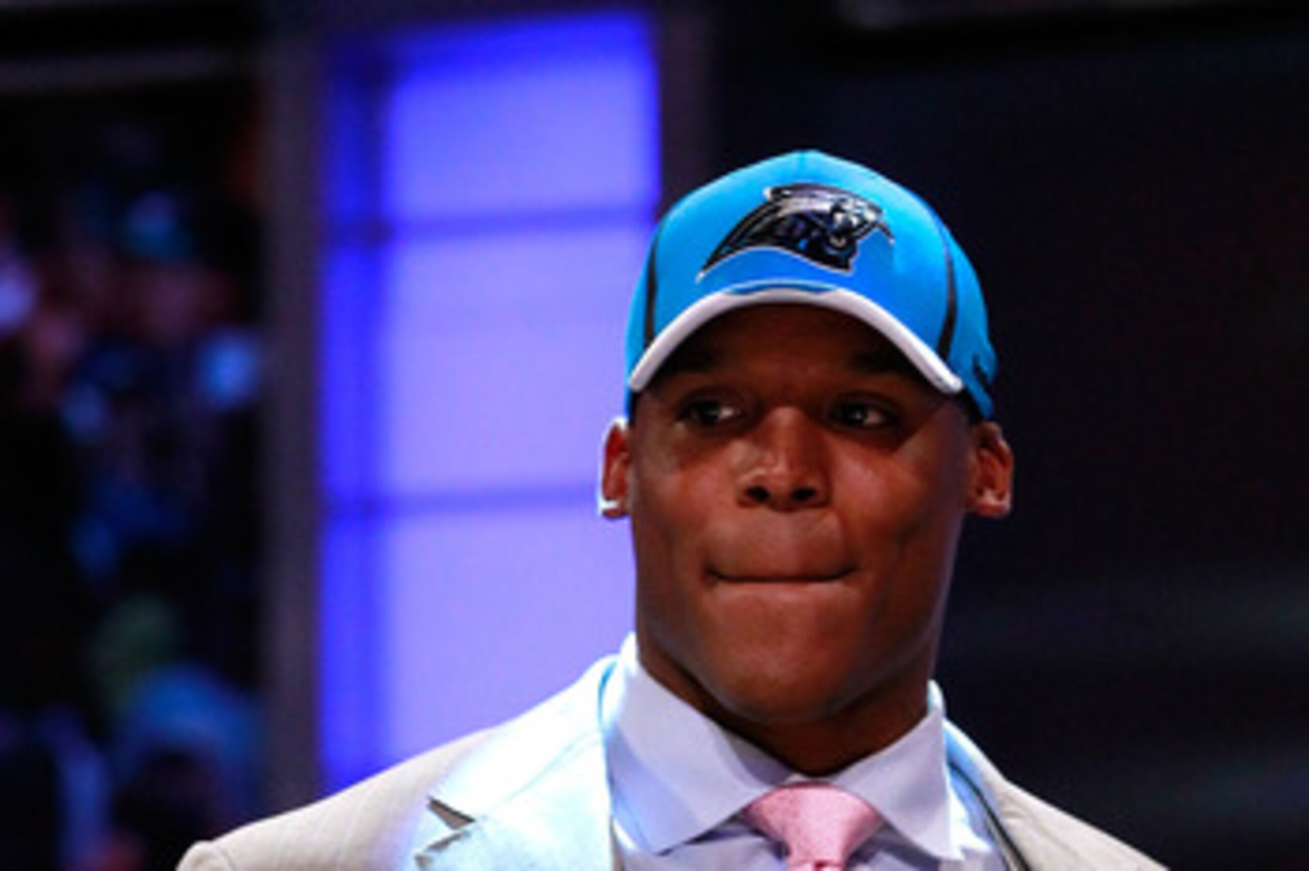 NEW YORK, NY - APRIL 28:  Cam Newton, #1 overall pick by the Carolina Panthers holds up a jersey on stage after he was picked during the 2011 NFL Draft at Radio City Music Hall on April 28, 2011 in New York City.  (Photo by Chris Trotman/Getty Images)