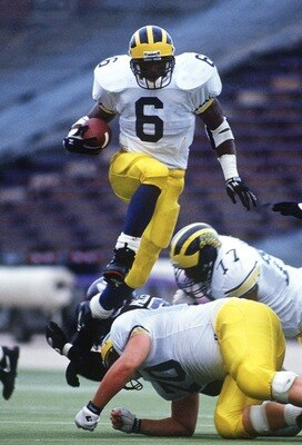 7 Nov 1992: MICHIGAN RUNNING TYRONE WHEATLEY BACK LEAPS OVER THE LINE OF SCRIMMAGE DURING THE WOLVERINES GAME AT THE NORTHWESTERN WILCATS IN EVANSTON, ILLINOIS.