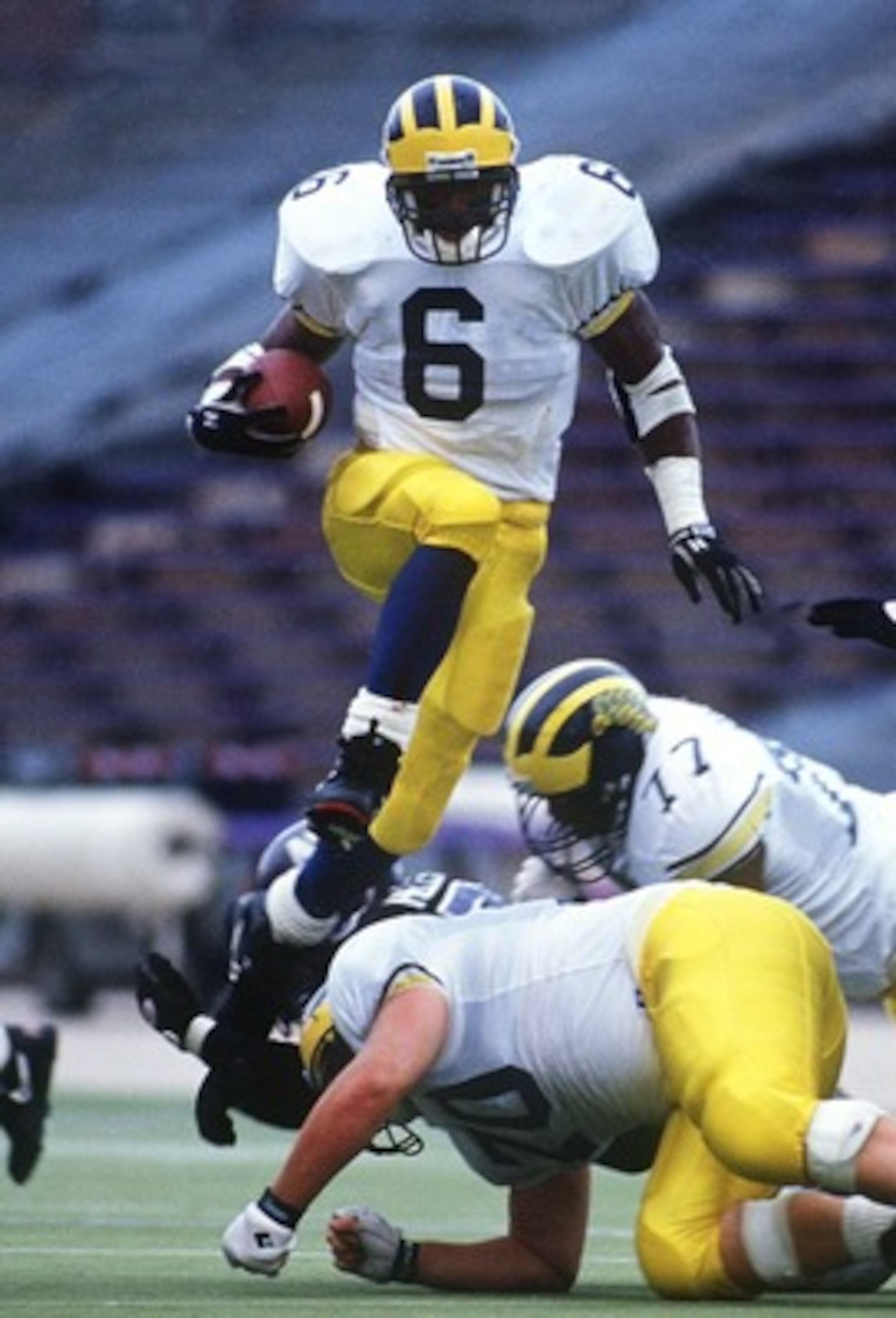 7 Nov 1992: MICHIGAN RUNNING TYRONE WHEATLEY BACK LEAPS OVER THE LINE OF SCRIMMAGE DURING THE WOLVERINES GAME AT THE NORTHWESTERN WILCATS IN EVANSTON, ILLINOIS.