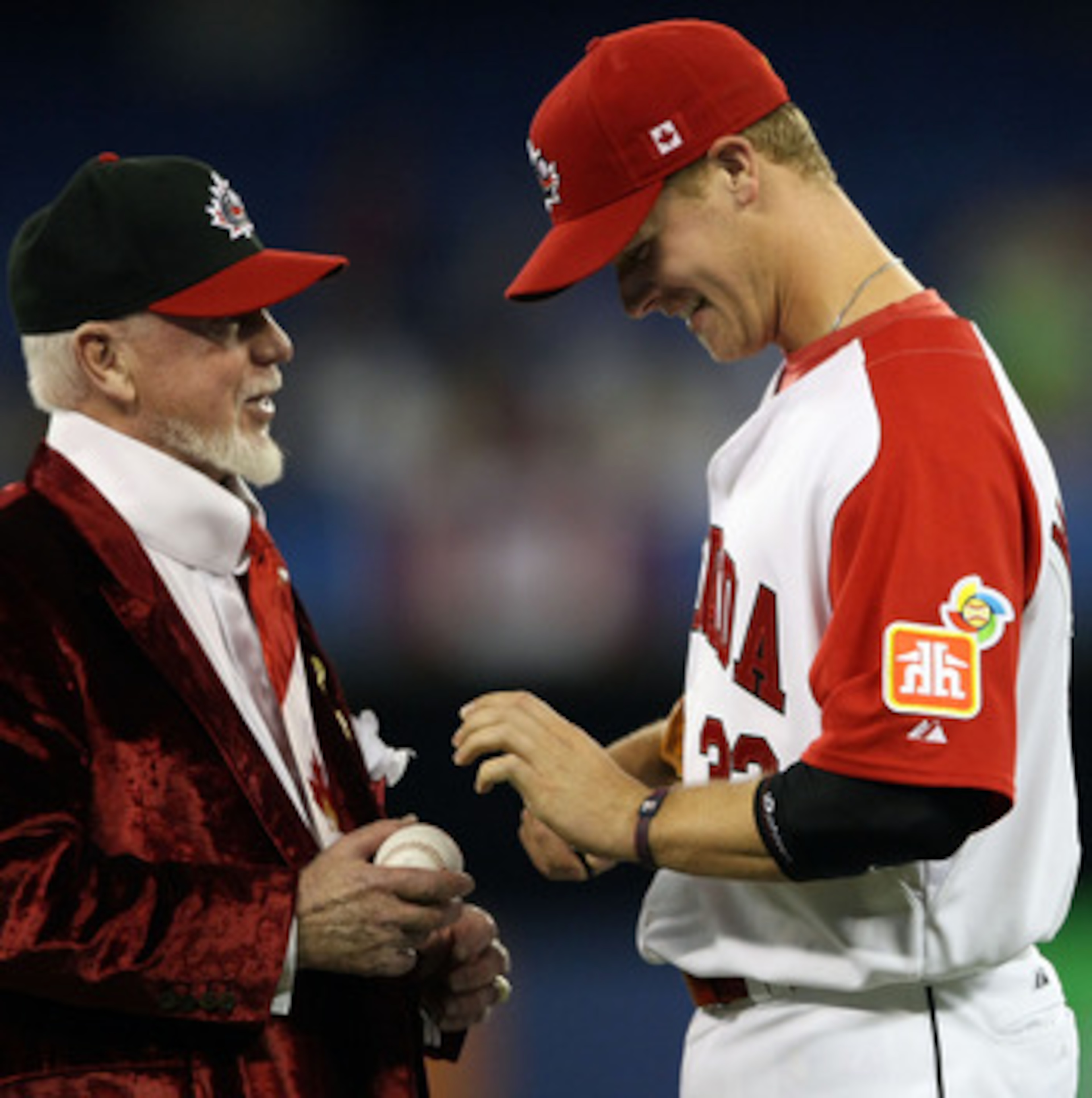 TORONTO, ON - MARCH 09:  Justin Morneau #22 of Canada signs an autograph for hockey broadcast legend Don Cherry during the 2009 World Baseball Classic Pool C game against Italy on March 9, 2009 at the Rogers Centre in Toronto, Ontario, Canada.  (Photo by 