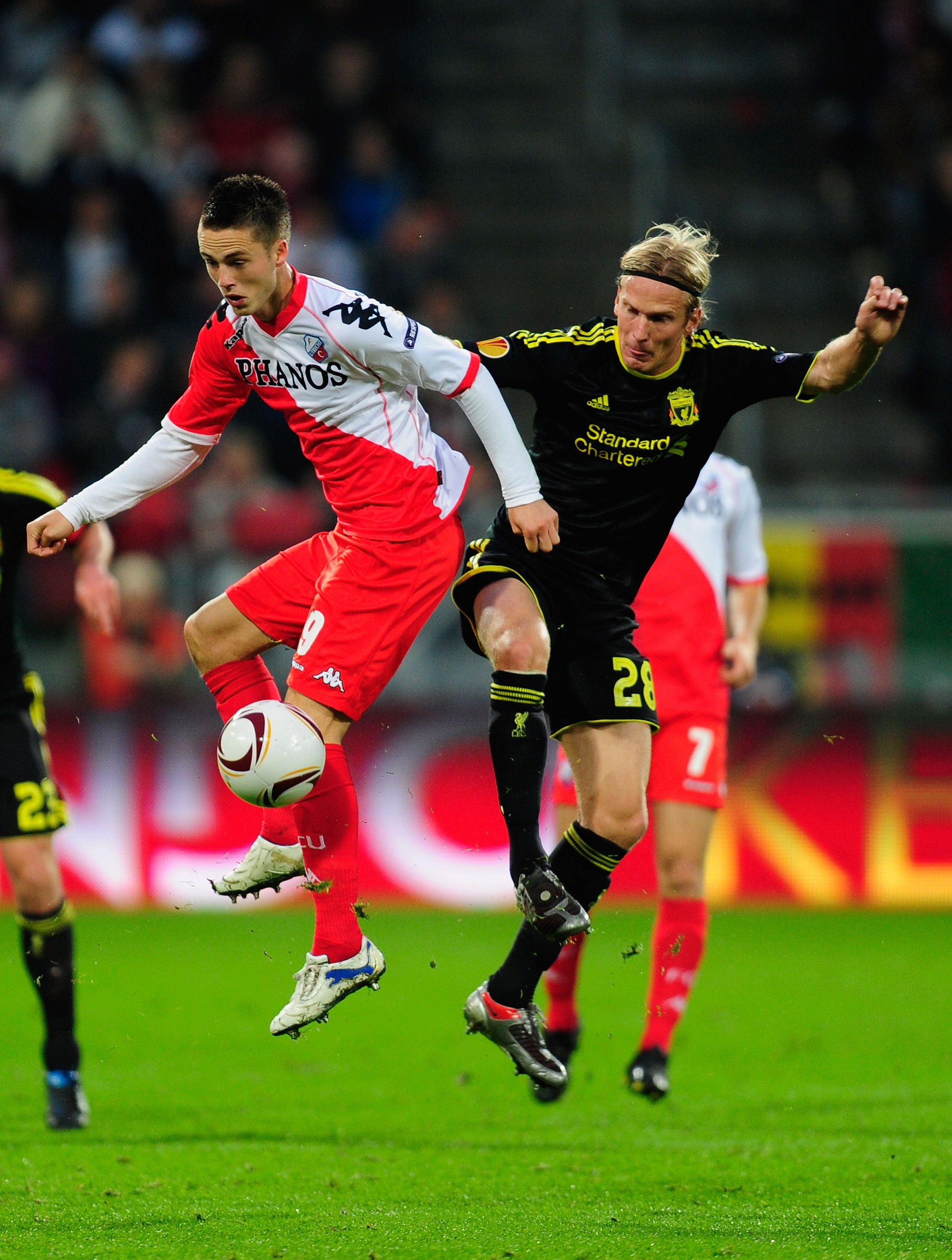 UTRECHT, NETHERLANDS - SEPTEMBER 30:  Christian Poulson of Liverpool (R) goes up for a challenge with Ricky Van Wolfswinkle of FC Utrecht during the UEFA Europa League match between FC Utrecht and Liverpool at the Stadion Galgenwaard on September 30, 2010