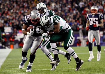 FOXBORO, MA - JANUARY 16:  Alge Crumpler #82 of the New England Patriots tries to avoid the tackle of Brodney Pool #22 of the New York Jets during their 2011 AFC divisional playoff game at Gillette Stadium on January 16, 2011 in Foxboro, Massachusetts.  (