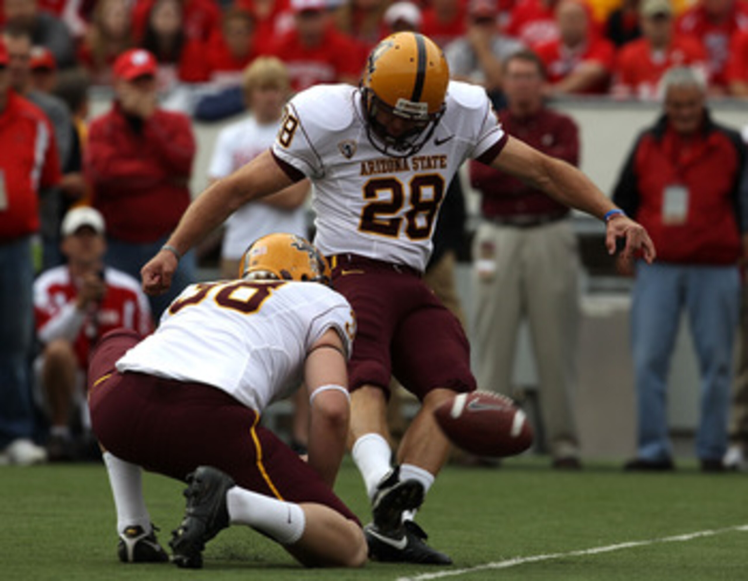 MADISON, WI - SEPTEMBER 18: Thomas Weber #28 of the Arizona State Sun Devils attempts a field goal out of the hold of Trevor Hawkins #38 against the Wisconsin Badgers at Camp Randall Stadium on September 18, 2010 in Madison, Wisconsin. Wisconsin defeated