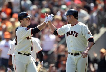 SAN FRANCISCO, CA - APRIL 24:  Aubrey Huff #17 congratulates Buster Posey #28 of the San Francisco Giants after Posey hits a two run home run against the Atlanta Braves at AT&T Park on April 24, 2011 in San Francisco, California.  (Photo by Ezra Shaw/Gett