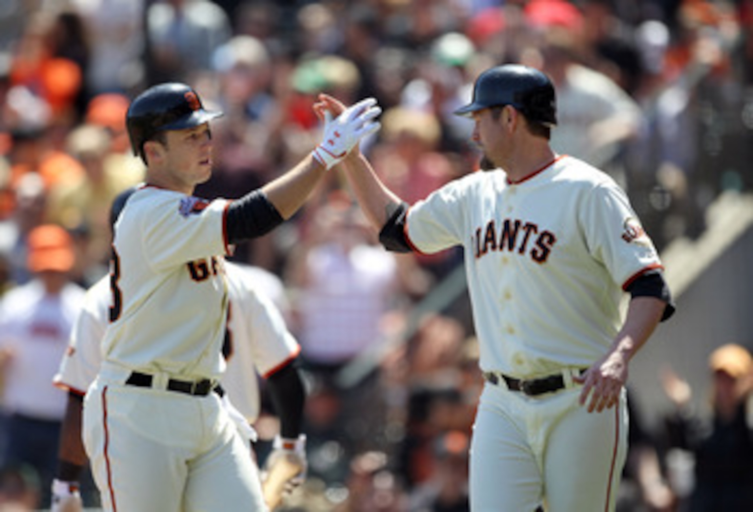 SAN FRANCISCO, CA - APRIL 24:  Aubrey Huff #17 congratulates Buster Posey #28 of the San Francisco Giants after Posey hits a two run home run against the Atlanta Braves at AT&T Park on April 24, 2011 in San Francisco, California.  (Photo by Ezra Shaw/Gett