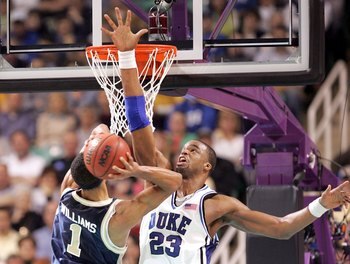 GREENSBORO, NC - MARCH 18:  Shelden Williams #23 of the Duke Blue Devils tries to block Omar Williams #1 of the George Washington Colonials during the Second Round of the 2006 NCAA Men's Basketball Tournament on March 18, 2006 at the Greensboro Coliseum i