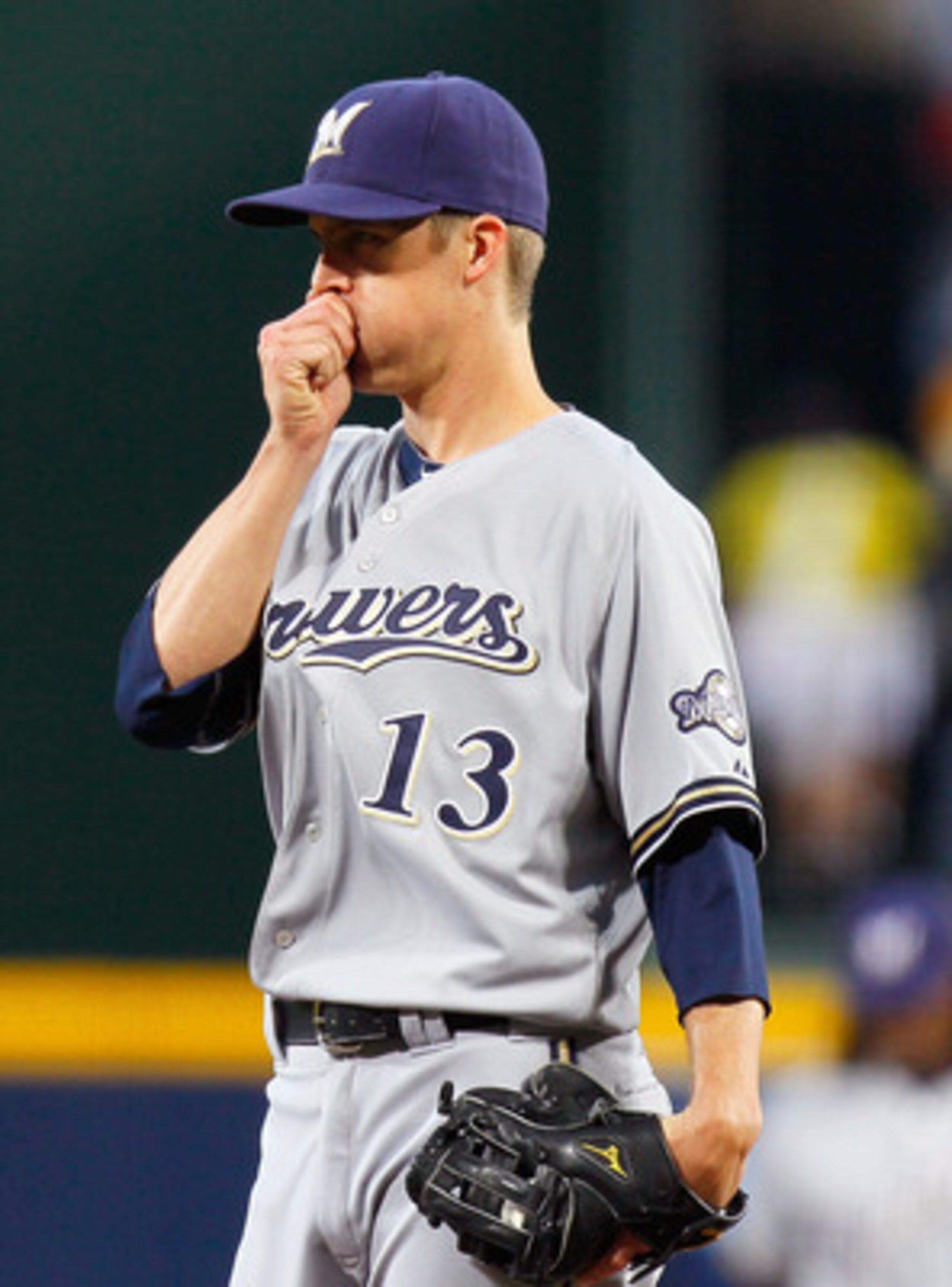 ATLANTA, GA - MAY 04:  Zack Greinke #13 of the Milwaukee Brewers tries to warm up his right hand in the first inning against the Atlanta Braves at Turner Field on May 4, 2011 in Atlanta, Georgia.  (Photo by Kevin C. Cox/Getty Images)