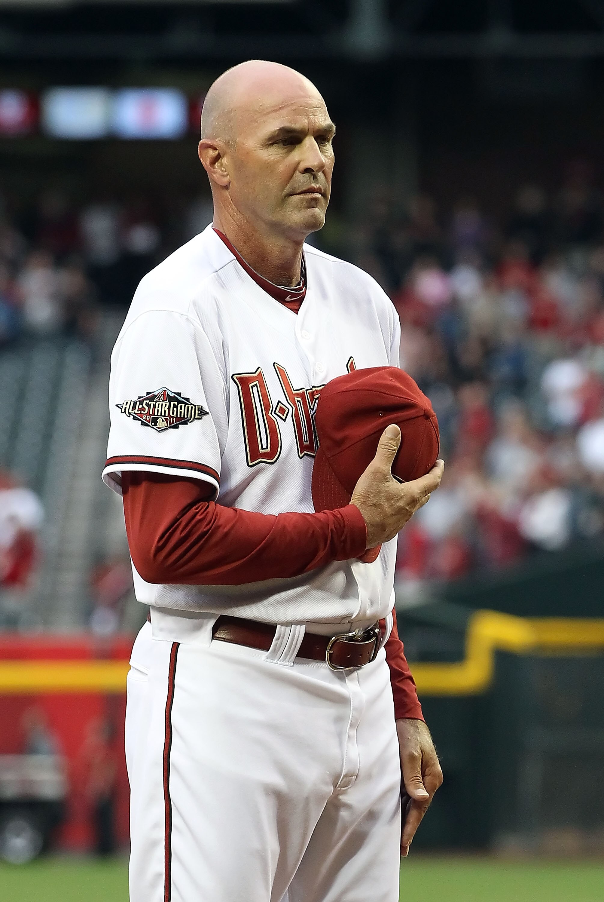 PHOENIX, AZ - APRIL 08:  Manager Kirk Gibson of the Arizona Diamondbacks stands attended for the National Anthem before the Major League Baseball home opening game against the Cincinnati Reds at Chase Field on April 8, 2011 in Phoenix, Arizona. The Diamon