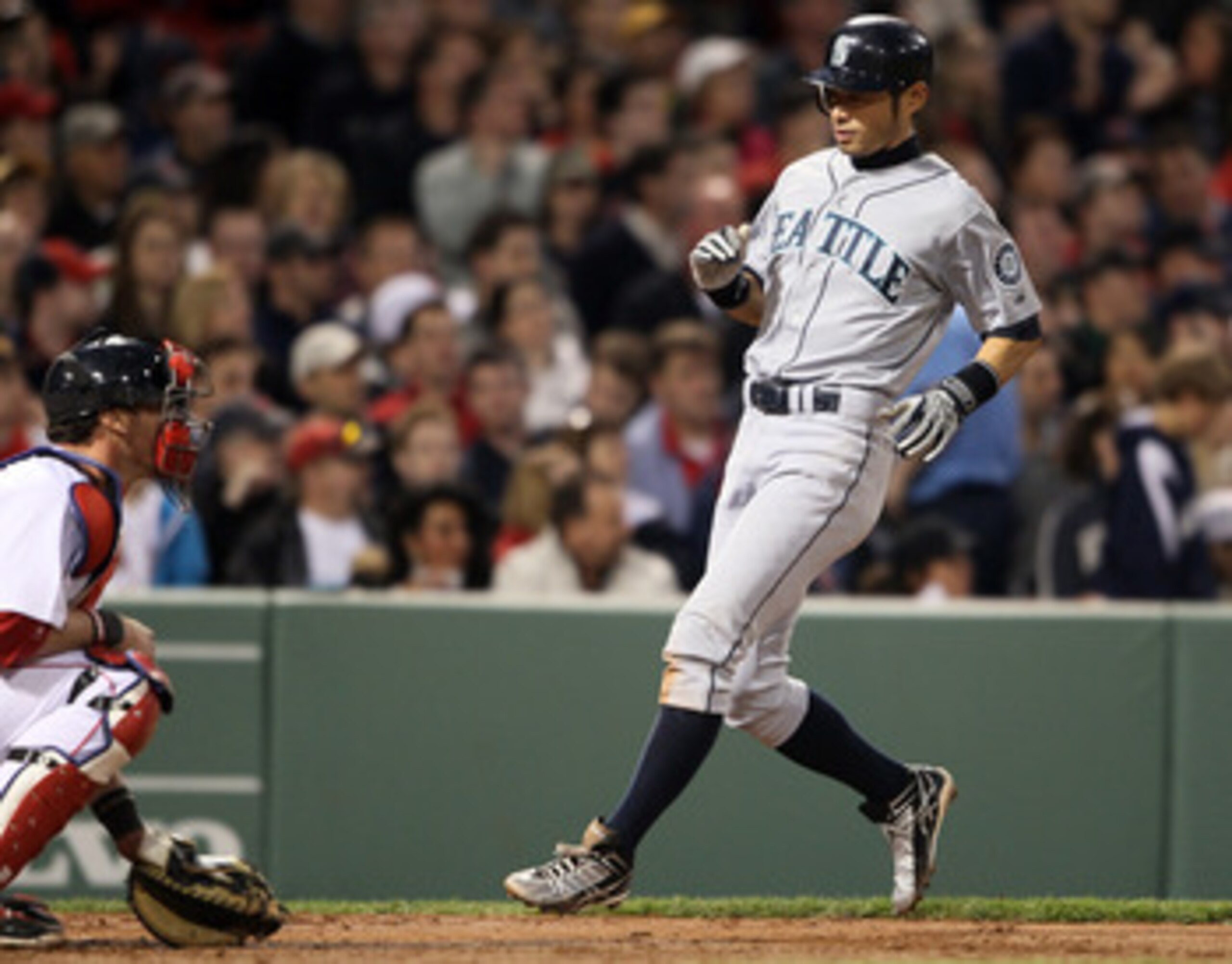 BOSTON, MA - APRIL 30:  Ichiro Suzuki #51 of the Seattle Mariners scores a run in the third inning against the Seattle Mariners Jarrod Saltalamacchia #39 of the Boston Red Sox defends on April 30, 2011 at Fenway Park in Boston, Massachusetts.  (Photo by E
