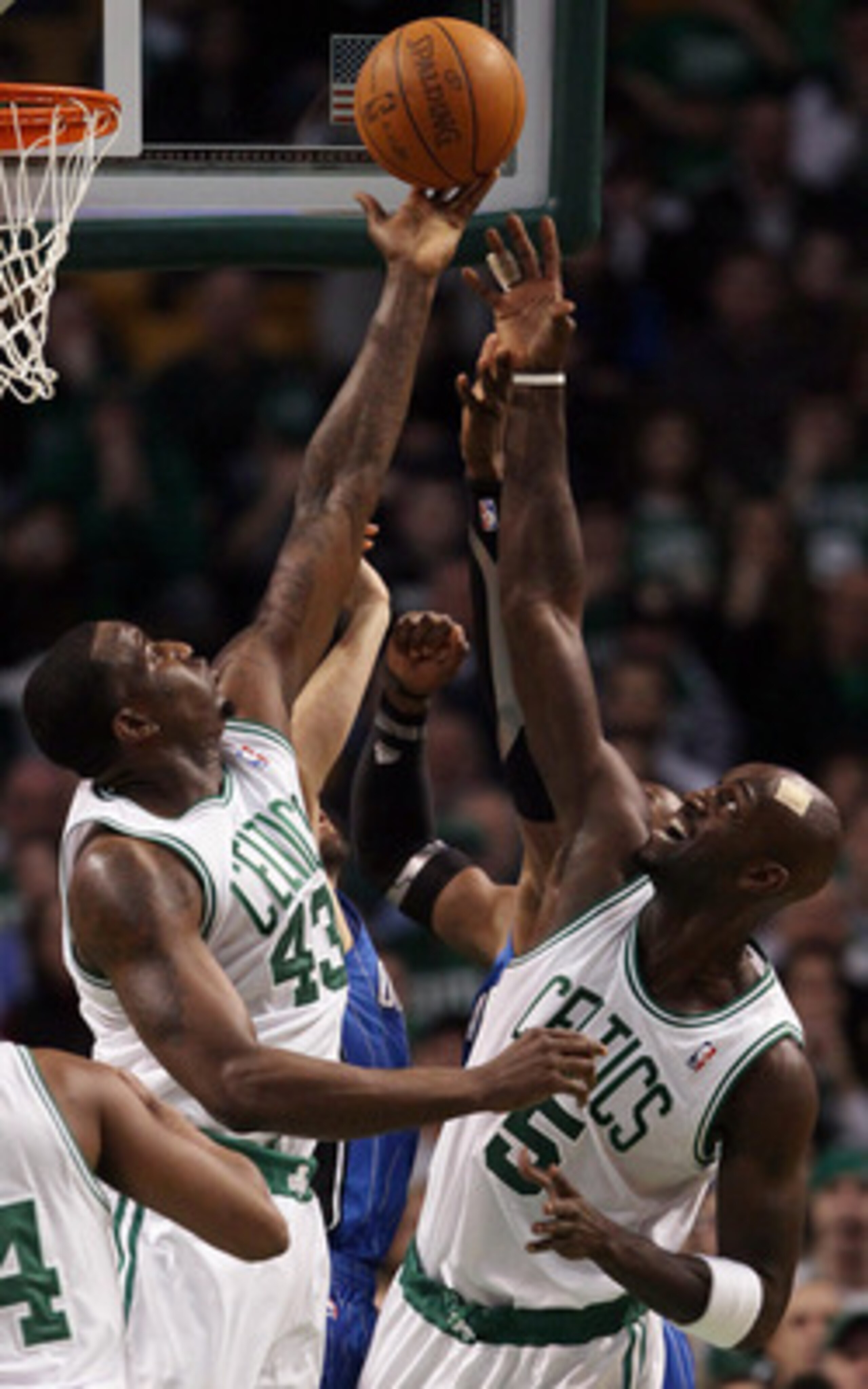 BOSTON, MA - FEBRUARY 06: Kendrick Perkins #43 and Kevin Garnett #5 of the Boston Celtics fight for the rebound with Dwight Howard #12 of the Orlando Magic on February 6, 2011 at the TD Garden in Boston, Massachusetts. The Celtics defeated the Magic 91-8 BOSTON, MA - FEBRUARY 06: Kendrick Perkins #43 and Kevin Garnett #5 of the Boston Celtics fight for the rebound with Dwight Howard #12 of the Orlando Magic on February 6, 2011 at the TD Garden in Boston, Massachusetts. The Celtics defeated the Magic 91-8