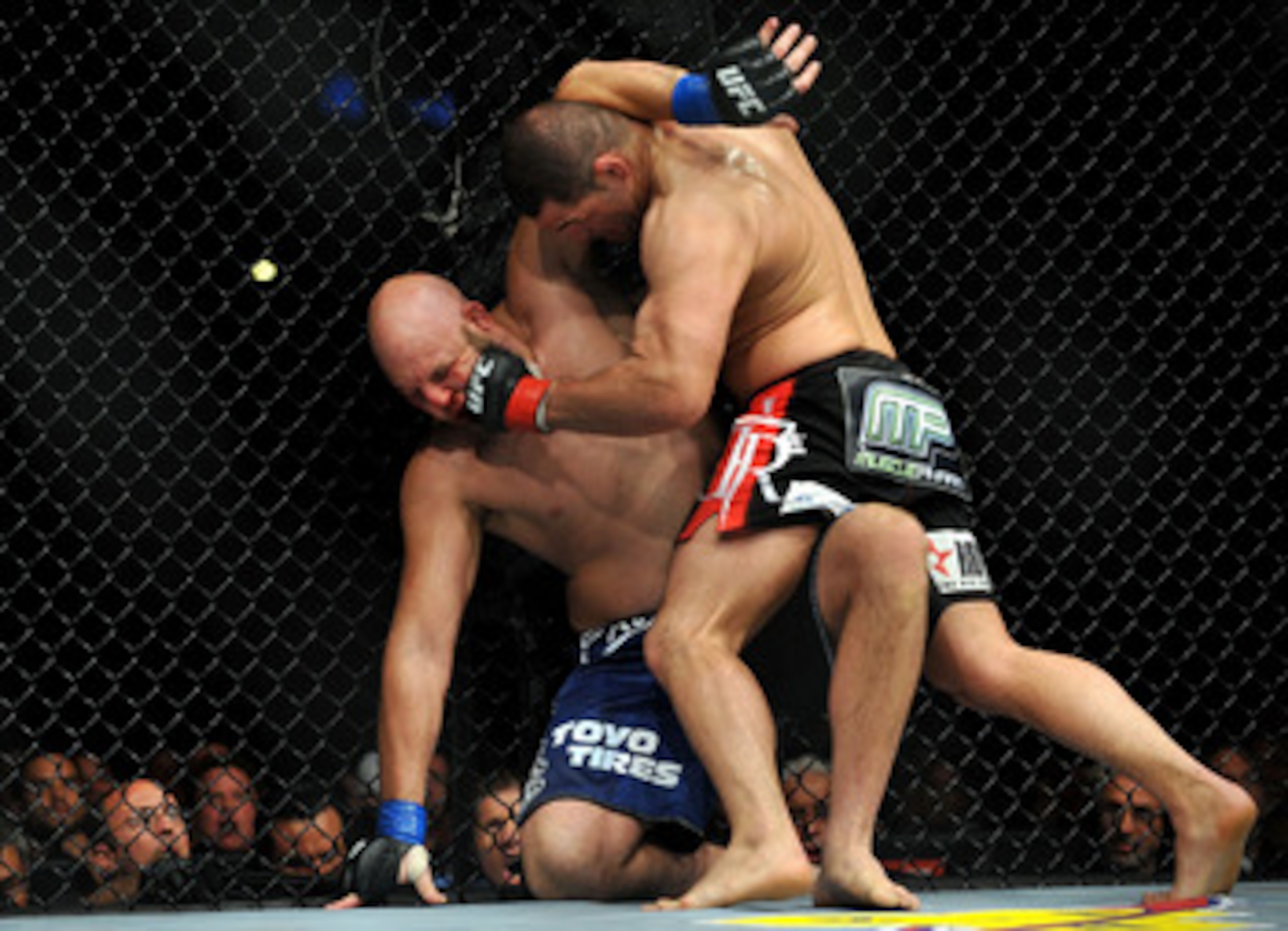 LOS ANGELES, CA - OCTOBER 24:  UFC fighter Cain Velasquez (R) hits UFC fighter Ben Rothwell (L) up against the fence during their Heavyweight bout at UFC 104: Machida vs. Shogun at Staples Center on October 24, 2009 in Los Angeles, California.  (Photo by 