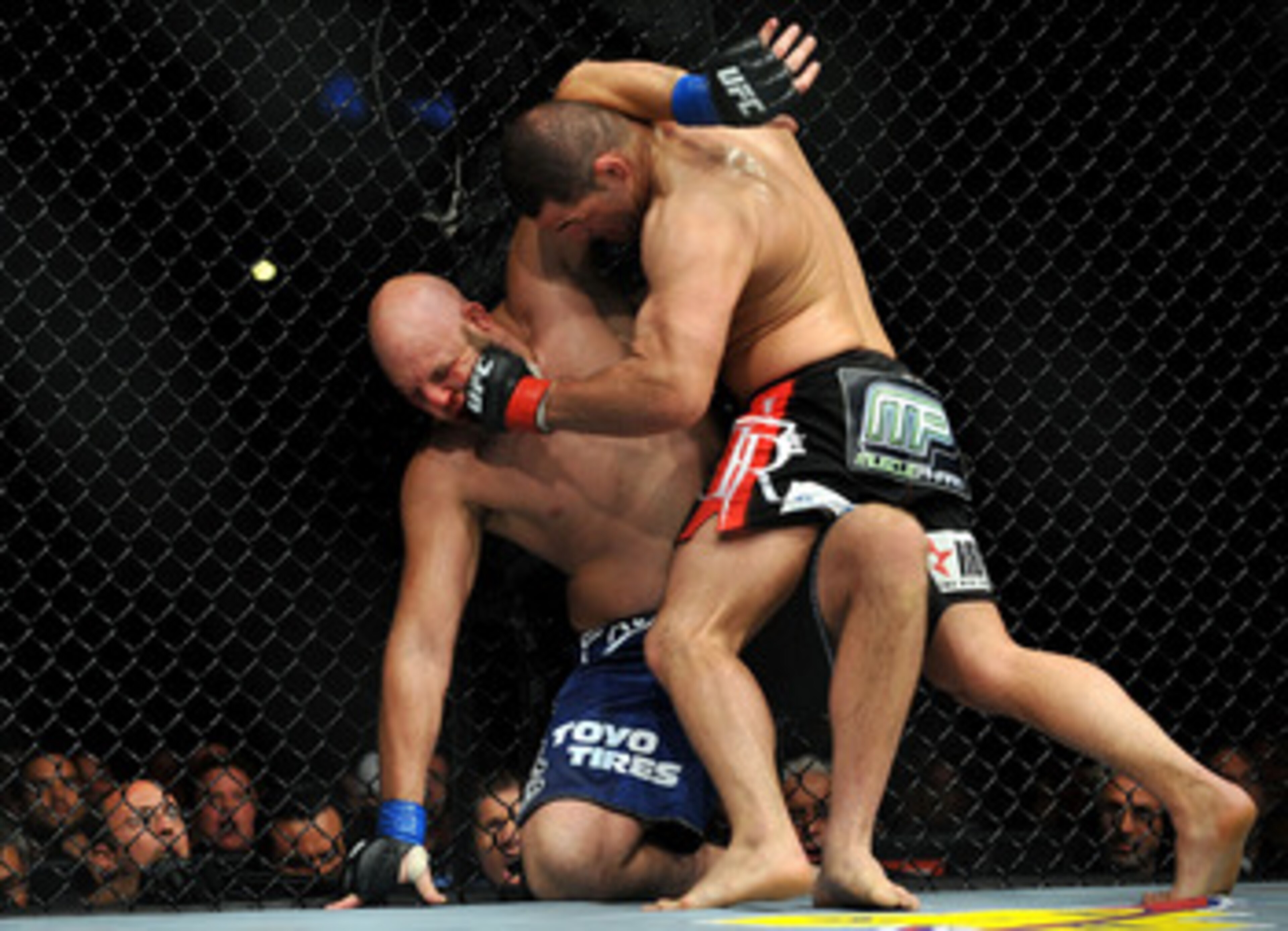 LOS ANGELES, CA - OCTOBER 24:  UFC fighter Cain Velasquez (R) hits UFC fighter Ben Rothwell (L) up against the fence during their Heavyweight bout at UFC 104: Machida vs. Shogun at Staples Center on October 24, 2009 in Los Angeles, California.  (Photo by 