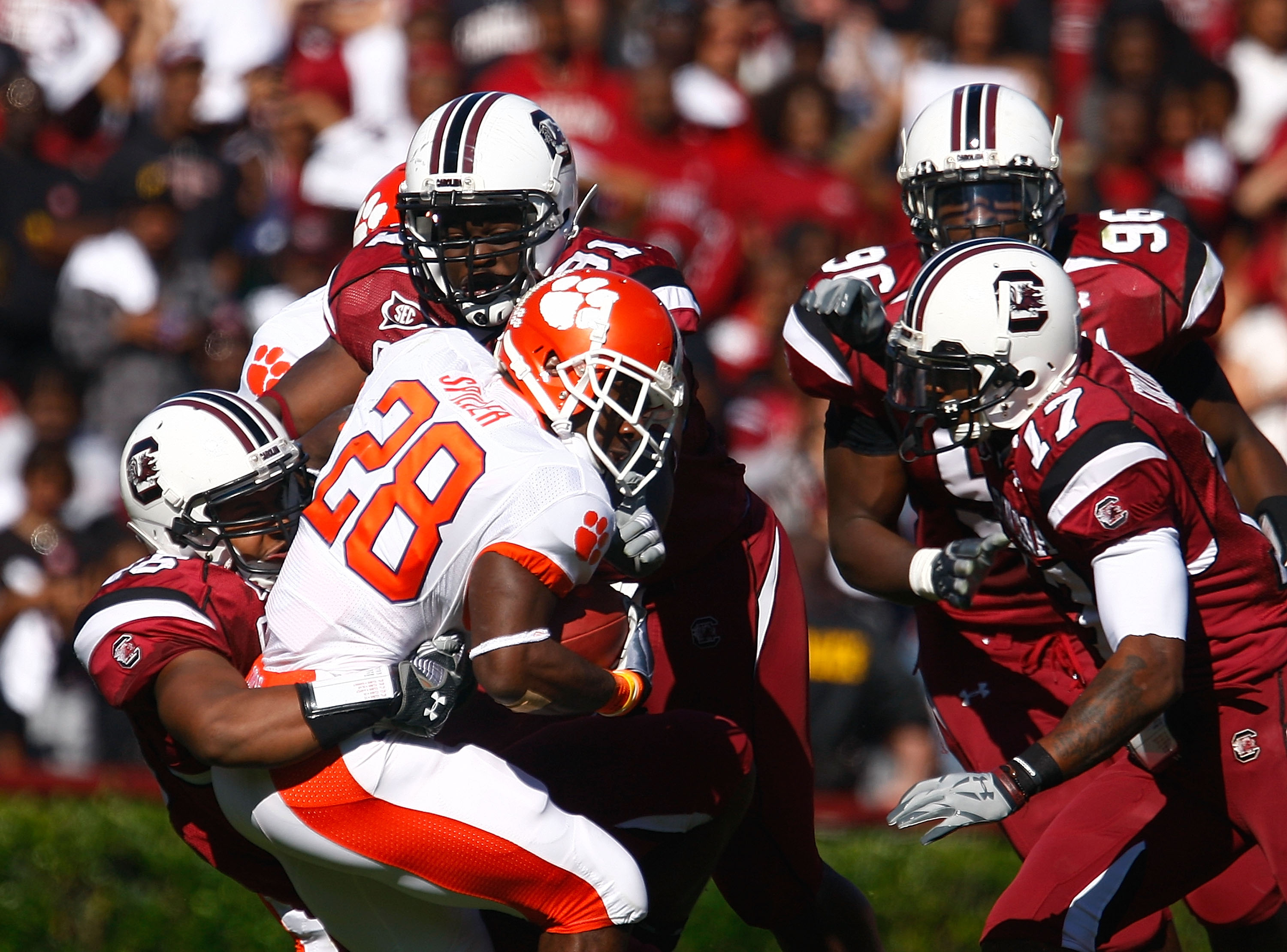 COLUMBIA, SC - NOVEMBER 28:  C.J. Spiller #28 of the Clemson Tigers is tackled by a group of South Carolina Gamecocks defenders during the first half at Williams-Brice Stadium on November 28, 2009 in Columbia, South Carolina.  (Photo by Scott Halleran/Get