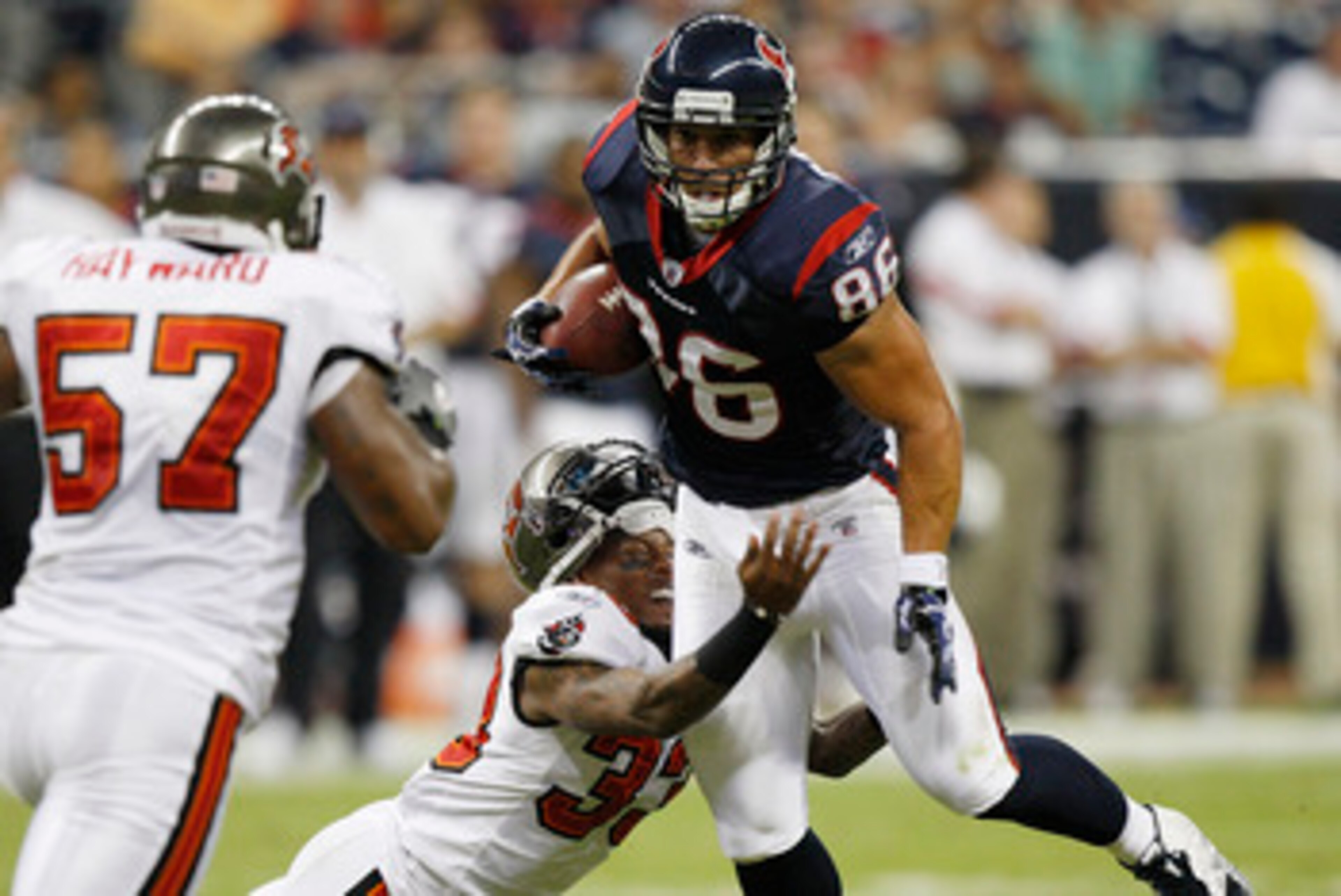 HOUSTON - SEPTEMBER 02:  Tight end James Casey #86 of the Houston Texans is tackled by cornerback Elbert Mack #33 of the Tampa Bay Buccaneers during a preseason football game at Reliant Stadium on September 2, 2010 in Houston, Texas.  (Photo by Bob Levey/