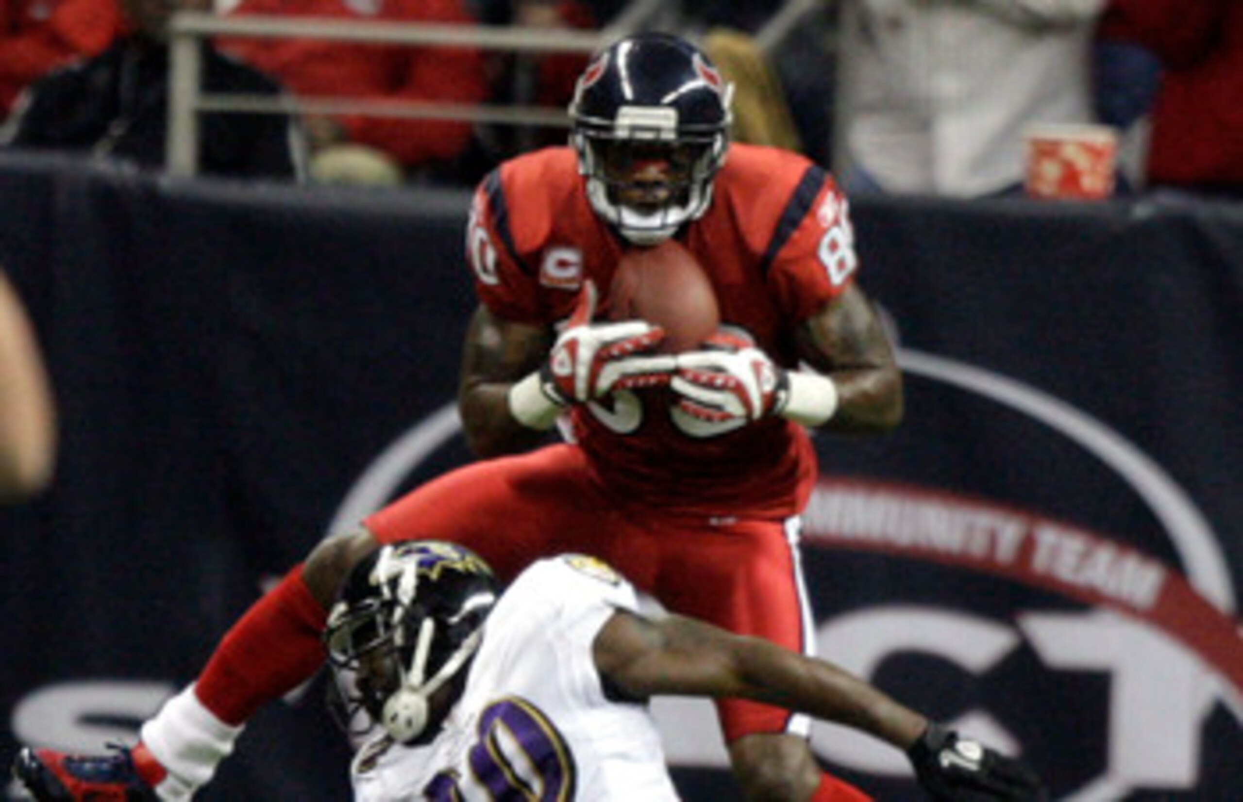HOUSTON, TX - DECEMBER 13:  Wide receiver Andre Johnson #80 of the Houston Texans scores on a pass as he goes over safety Ed Reed #20 of the Baltimore Ravens in the second quarter at Reliant Stadium on December 13, 2010 in Houston, Texas.  (Photo by Bob L