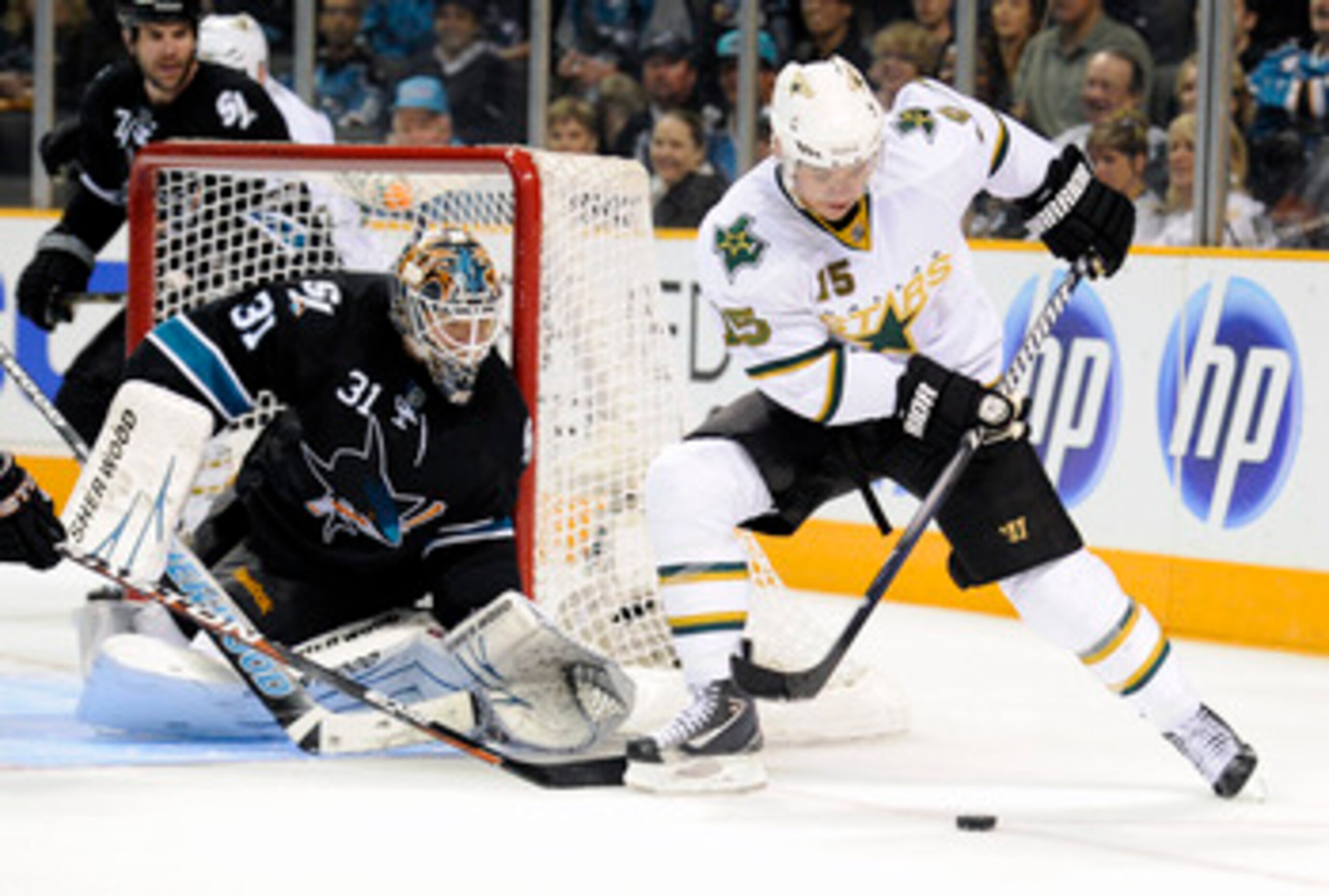 SAN JOSE, CA - MARCH 31: Antti Niemi #31 of  the San Jose Sharks defends his goal against Jamie Langenbrunner #15 of the Dallas Stars in the third period during an NHL hockey game at the HP Pavilion on March 31, 2011 in San Jose, California. The Sharks wo