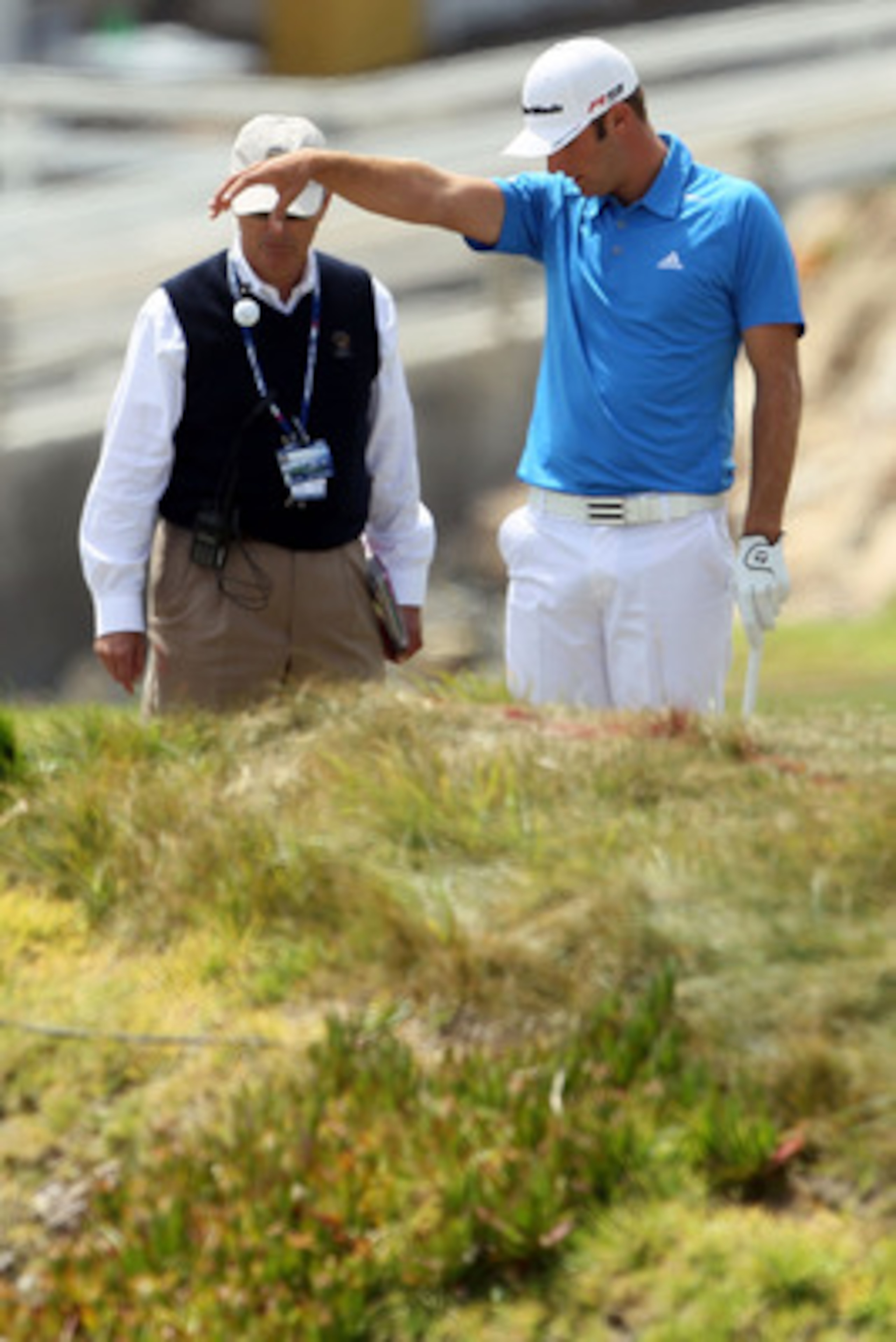 PEBBLE BEACH, CA - JUNE 20:  Dustin Johnson takes a penalty drop on the fourth hole alongside a USGA rules official during the final round of the 110th U.S. Open at Pebble Beach Golf Links on June 20, 2010 in Pebble Beach, California.  (Photo by Jeff Gros