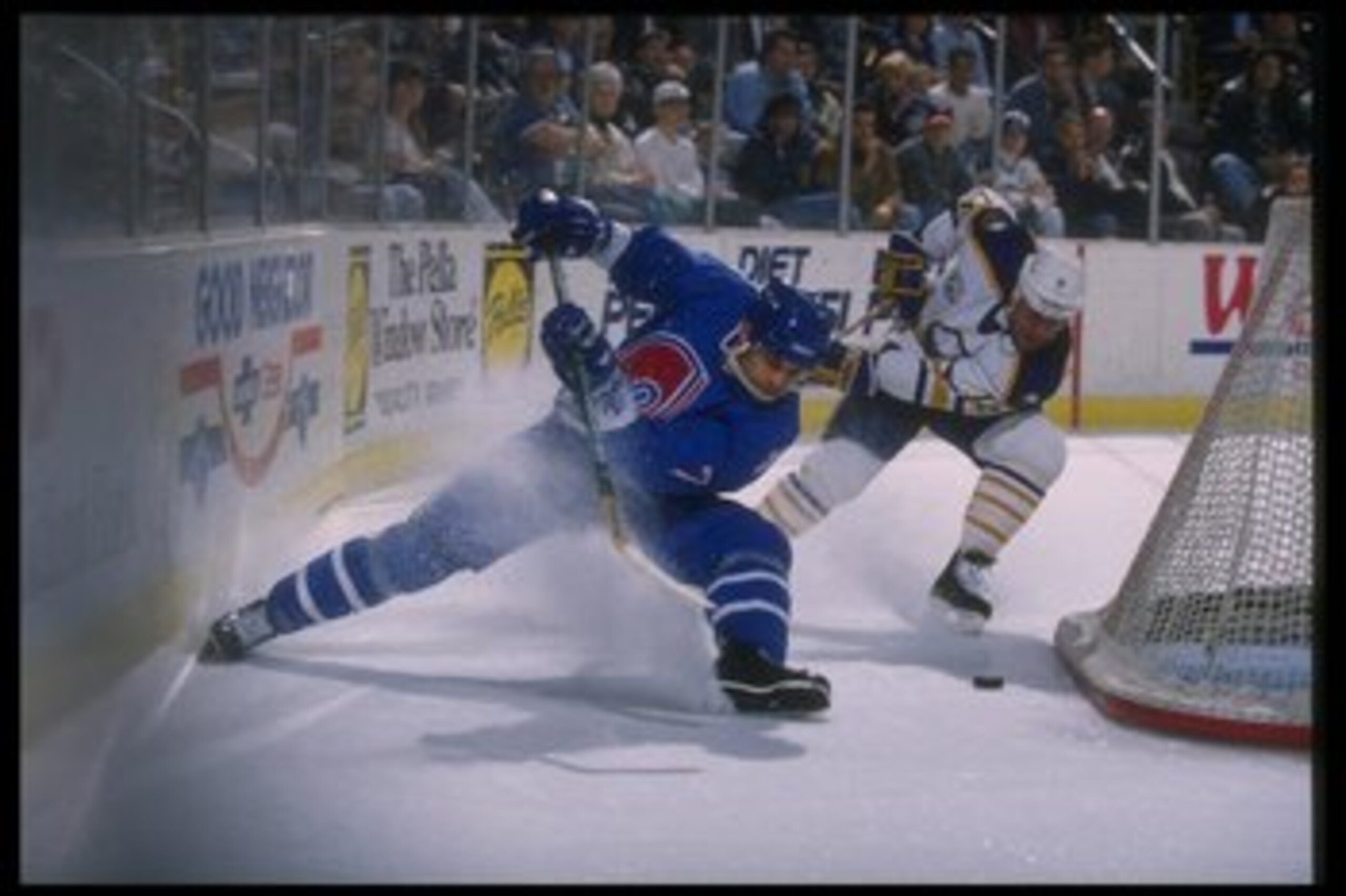 28 Mar 1995:  Defenseman Curtis Leschyshyn of the Quebec Nordiques (left) goes for the puck during a game against the Buffalo Sabres at Memorial Auditorium in Buffalo, New York.  The Sabres won the game, 5-3. Mandatory Credit: Rick Stewart  /Allsport