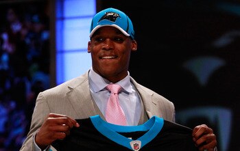 NEW YORK, NY - APRIL 28:  Cam Newton, #1 overall pick by the Carolina Panthers holds up a jersey on stage after he was picked during the 2011 NFL Draft at Radio City Music Hall on April 28, 2011 in New York City.  (Photo by Chris Trotman/Getty Images)