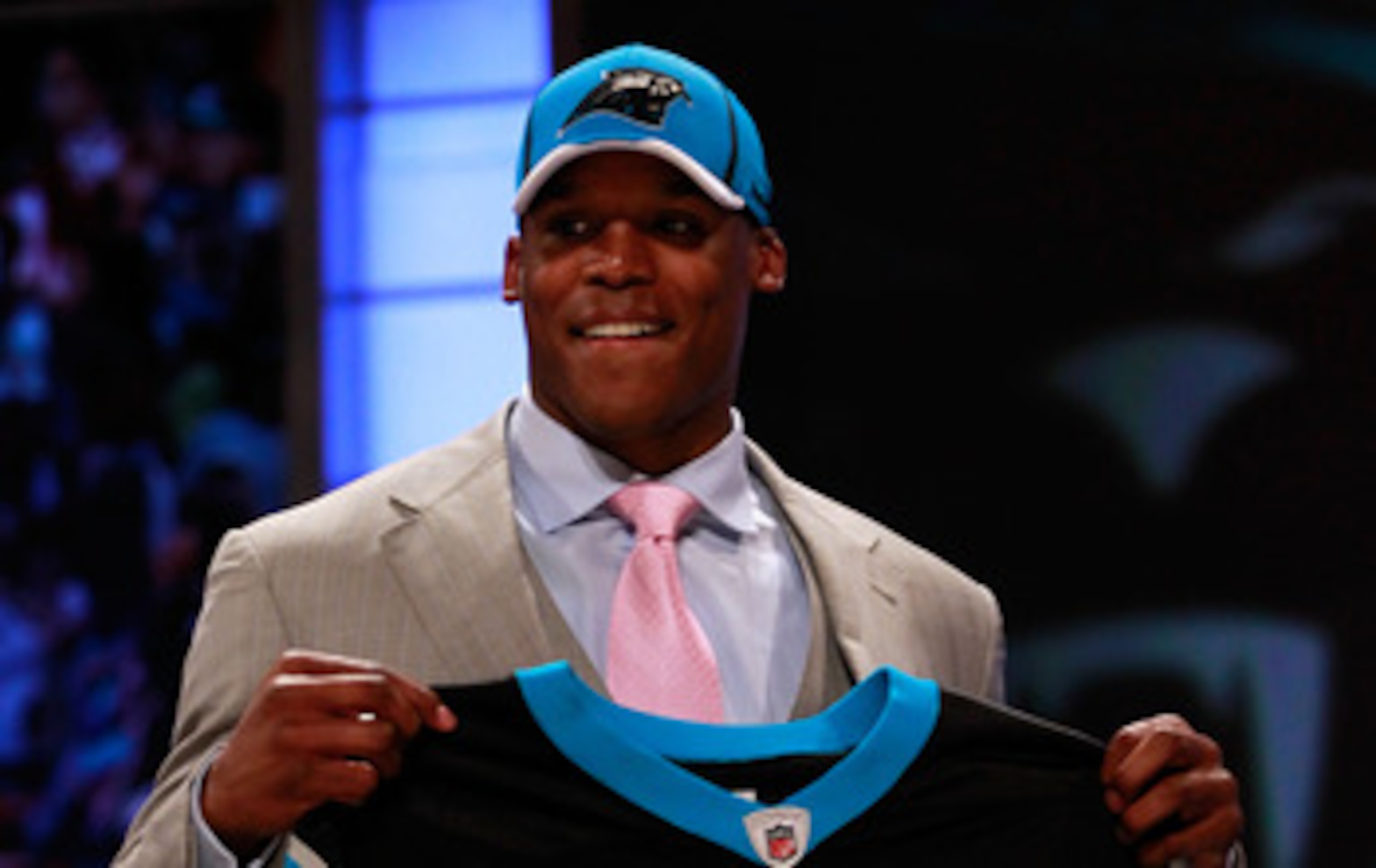 NEW YORK, NY - APRIL 28: Cam Newton, #1 overall pick by the Carolina Panthers holds up a jersey on stage after he was picked during the 2011 NFL Draft at Radio City Music Hall on April 28, 2011 in New York City. (Photo by Chris Trotman/Getty Images) NEW YORK, NY - APRIL 28: Cam Newton, #1 overall pick by the Carolina Panthers holds up a jersey on stage after he was picked during the 2011 NFL Draft at Radio City Music Hall on April 28, 2011 in New York City. (Photo by Chris Trotman/Getty Images)