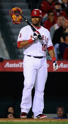 ANAHEIM, CA - APRIL 21:  Vernon Wells #10 of the the Los Angeles Angels of Anaheim holds the face mask of catcher Jason Veritek #33 the Boston Red Sox at the end of his bat during the seventh inning of the baseball game at Angel Stadium of Anaheim on Apri
