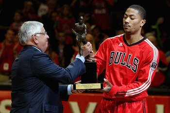 CHICAGO, IL - MAY 04: Derrick Rose #1 of the Chicago Bulls accepts the Maurice Podoloff Trophy awarded to the NBA Most Valuable Player from Commissoner David Stern before taking on the Atlanta Hawks in Game Two of the Eastern Conference Semifinals in the 