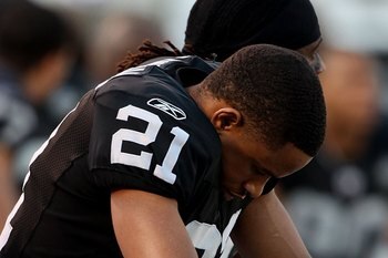 OAKLAND, CA - JANUARY 03:  Nnamdi Asomugha #21 of the Oakland Raiders sits on the bench against the Baltimore Ravens during an NFL game at Oakland-Alameda County Coliseum on January 3, 2010 in Oakland, California.  (Photo by Jed Jacobsohn/Getty Images)