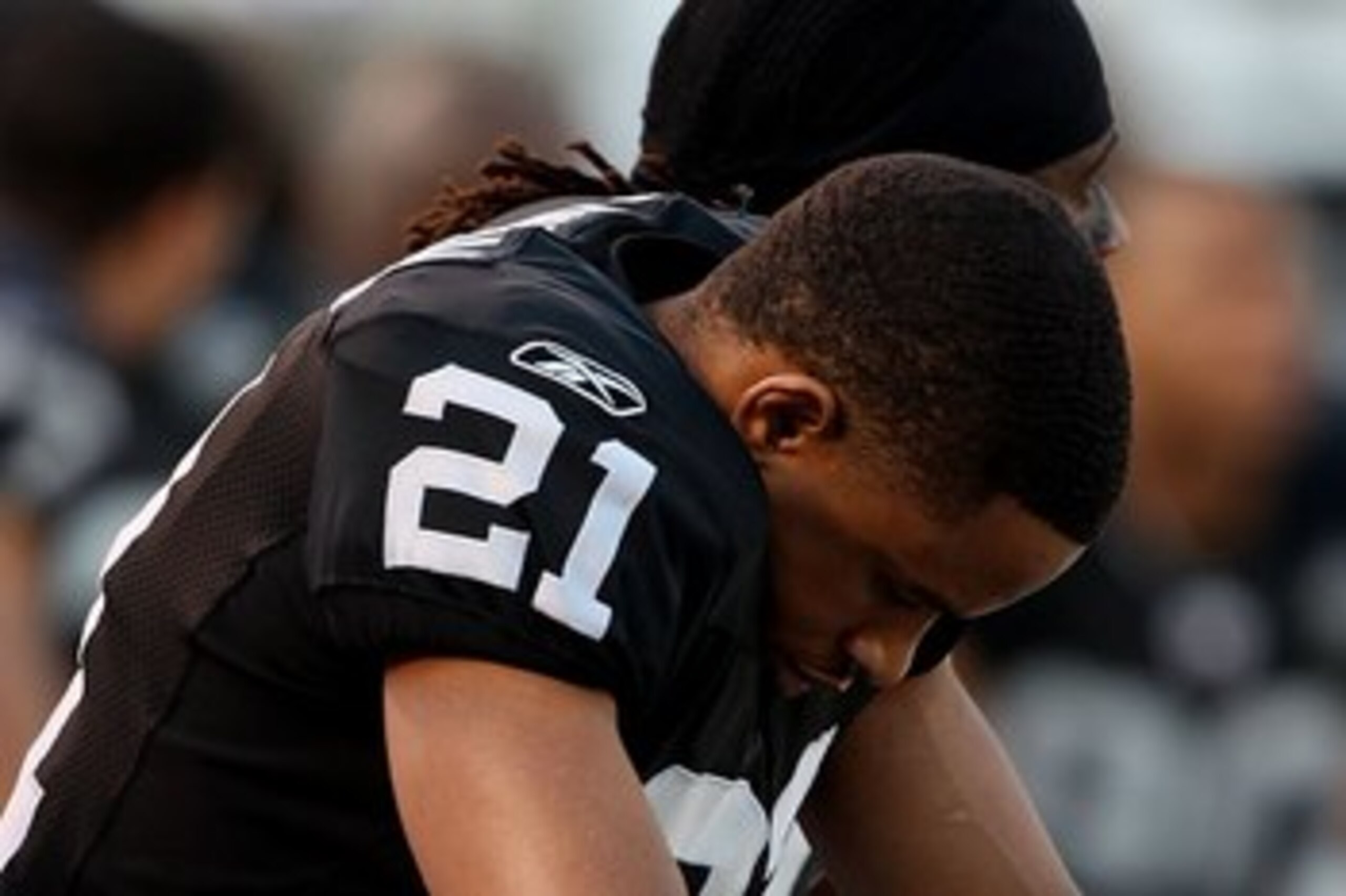 OAKLAND, CA - JANUARY 03:  Nnamdi Asomugha #21 of the Oakland Raiders sits on the bench against the Baltimore Ravens during an NFL game at Oakland-Alameda County Coliseum on January 3, 2010 in Oakland, California.  (Photo by Jed Jacobsohn/Getty Images)