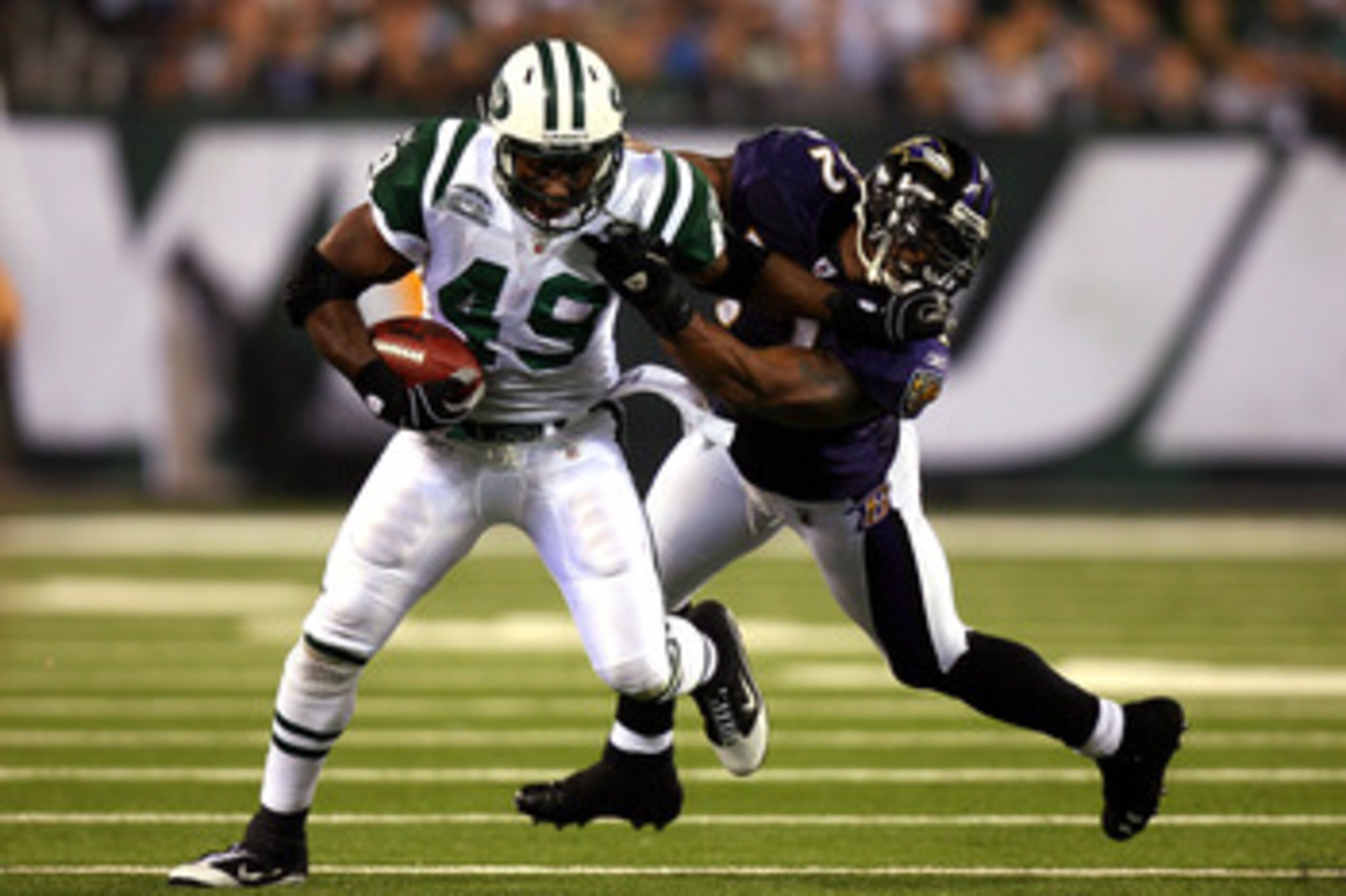 EAST RUTHERFORD, NJ - SEPTEMBER 13:  Tony Richardson #49 of the New York Jets stiff arms Ray Lewis #52 of the Baltimore Ravens during their home opener at the New Meadowlands Stadium on September 13, 2010 in East Rutherford, New Jersey.  (Photo by Andrew 