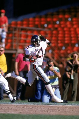 SAN FRANCISCO - OCTOBER 13:  Defensive back Deion Sanders #21 of the Atlanta Falcons looks back over his shoulder as he celebrates running the ball against the San Francisco 49ers during a game at Candlestick Park on October 13, 1991 in San Francisco, Cal