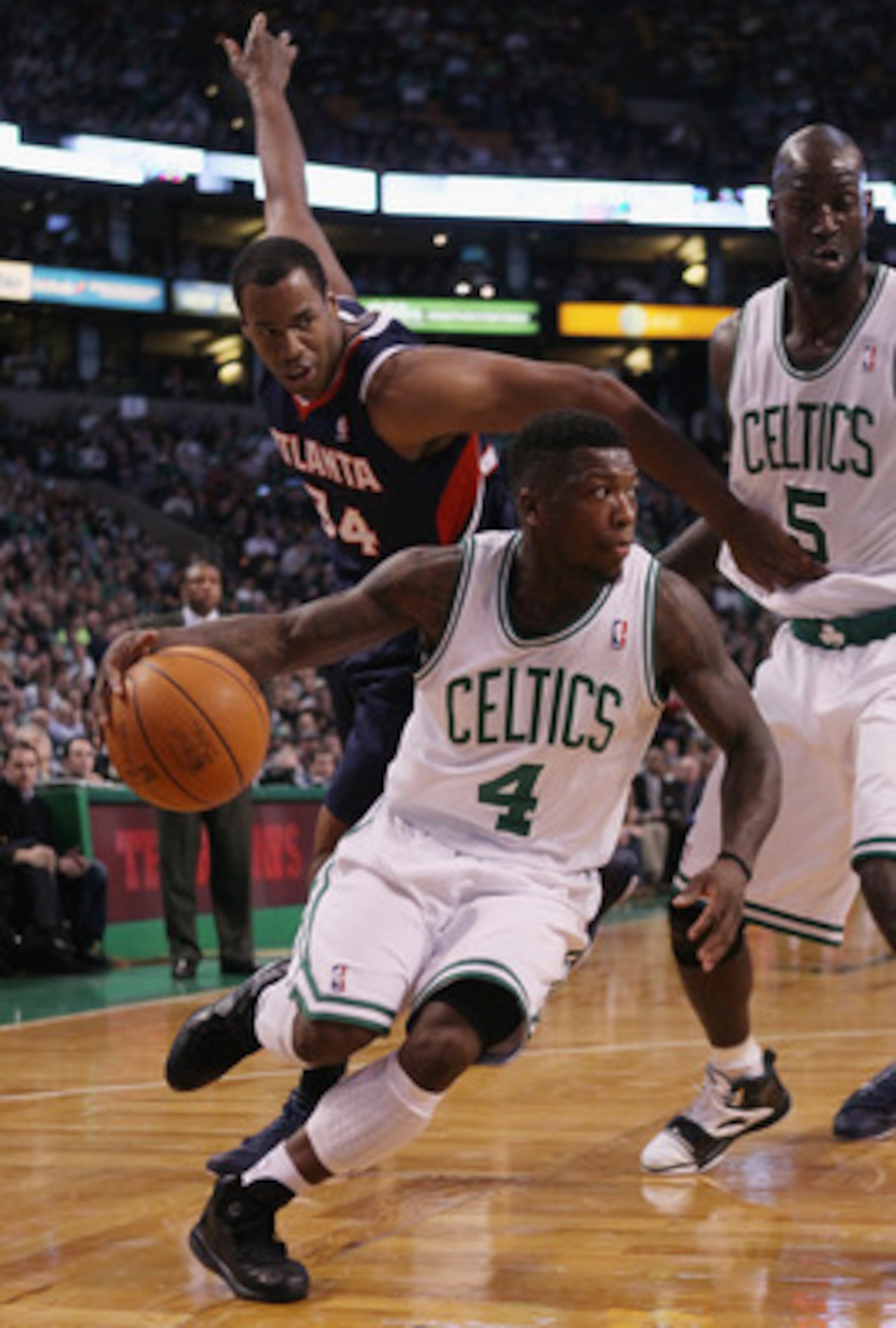 BOSTON, MA - DECEMBER 16: Nate Robinson #4 of the Boston Celtics drives around Jason Collins #34 of the Atlanta Hawks as Kevin Garnett #5 of the Celtics blocks on December 16, 2010 at the TD Garden in Boston, Massachusetts. NOTE TO USER: User expressly BOSTON, MA - DECEMBER 16: Nate Robinson #4 of the Boston Celtics drives around Jason Collins #34 of the Atlanta Hawks as Kevin Garnett #5 of the Celtics blocks on December 16, 2010 at the TD Garden in Boston, Massachusetts. NOTE TO USER: User expressly