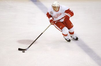 DETROIT, MI - JUNE 6:  Center Sergei Fedorov #91 of the Detroit Red Wings skates with the puck against the Carolina Hurricanes during game 2 of the 2002 Stanley Cup Finals on June 6, 2002 at Joe Louis Arena in Detroit, Michigan.  The Red Wings defeated th