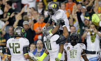 GLENDALE, AZ - JANUARY 10:  (R-L) LaMichael James #21 and Ramsen Golpashin #70 of the Oregon Ducks celebrate James' eight-yard touchdown reception in the second quarter against the Auburn Tigers during the Tostitos BCS National Championship Game at Univer
