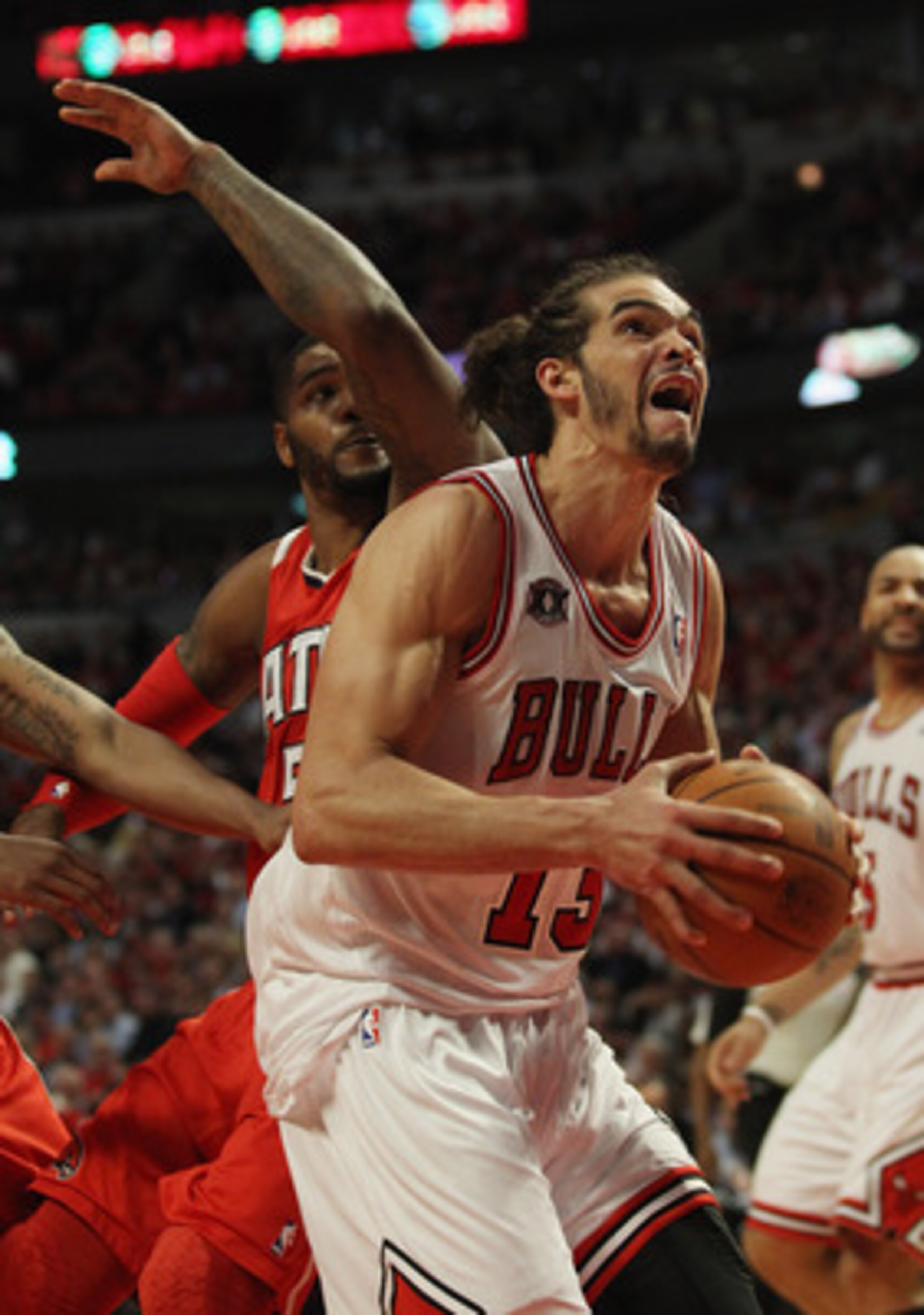CHICAGO, IL - MAY 04: Joakim Noah #13 of the Chicago Bulls moves to the basket past Josh Smith #5 of the Atlanta Hawks in Game Two of the Eastern Conference Semifinals in the 2011 NBA Playoffs at the United Center on May 4, 2011 in Chicago, Illinois. The 