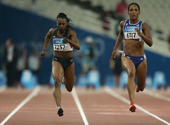 ATHENS - AUGUST 20:  Gail Devers of USA and Christine Arron of France compete during the women's 100 metre event on August 20, 2004 during the Athens 2004 Summer Olympic Games at the Olympic Stadium in the Sports Complex in Athens, Greece. (Photo by Andy