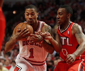 CHICAGO, IL - MAY 04: Derrick Rose #1 of the Chicago Bulls hangs on to the ball as he moves past Jeff Teague #0 of the Atlanta Hawks in Game Two of the Eastern Conference Semifinals in the 2011 NBA Playoffs at the United Center on May 4, 2011 in Chicago, 