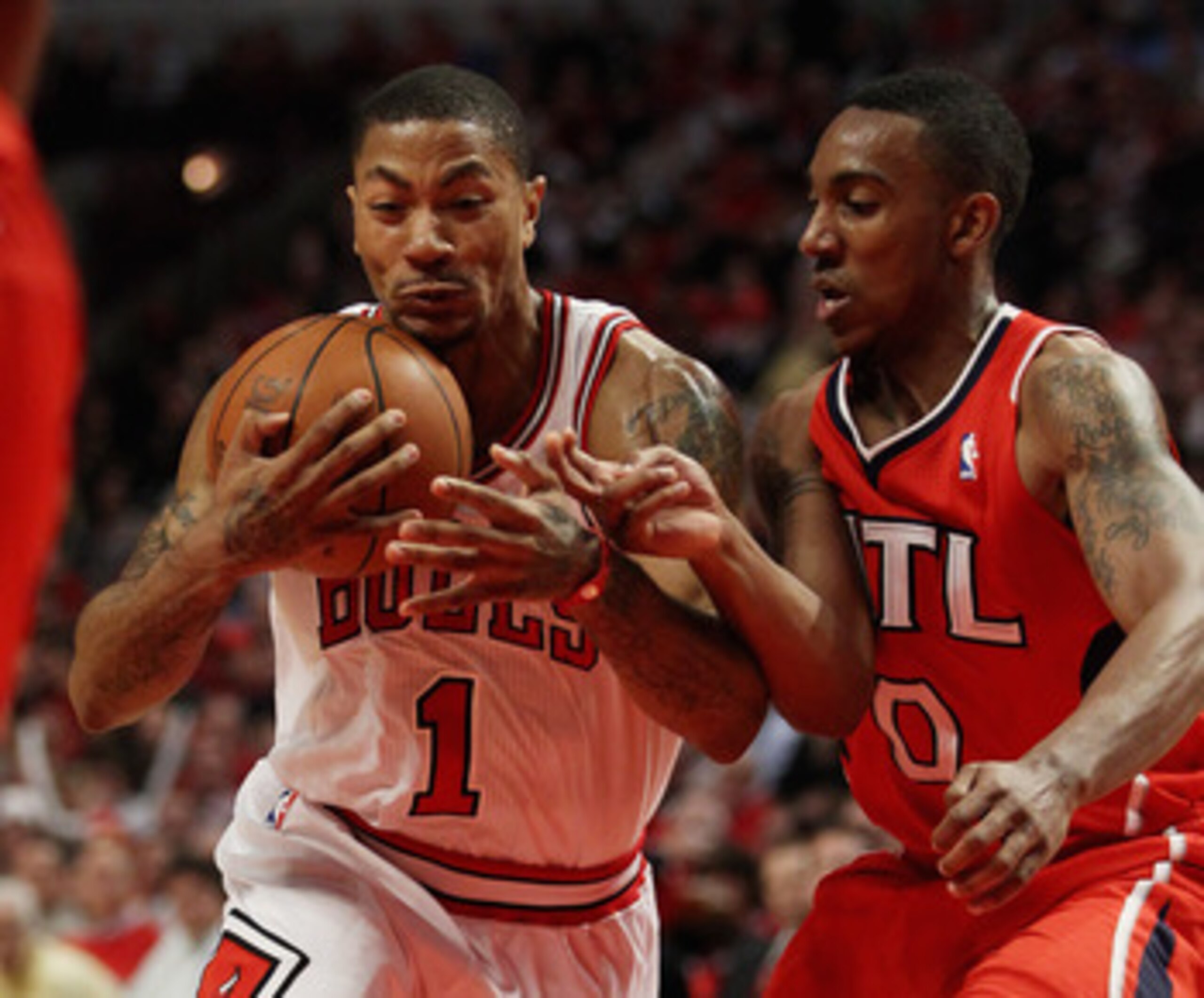 CHICAGO, IL - MAY 04: Derrick Rose #1 of the Chicago Bulls hangs on to the ball as he moves past Jeff Teague #0 of the Atlanta Hawks in Game Two of the Eastern Conference Semifinals in the 2011 NBA Playoffs at the United Center on May 4, 2011 in Chicago, 
