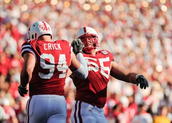 LINCOLN, NE - OCTOBER 30: Defensive tackle Baker Steinkuhler #55  of the Nebraska Cornhuskers high fives teammate  defensive tackle Jared Crick #94 after a third down stop during second half action of their game at Memorial Stadium on October 30, 2010 in