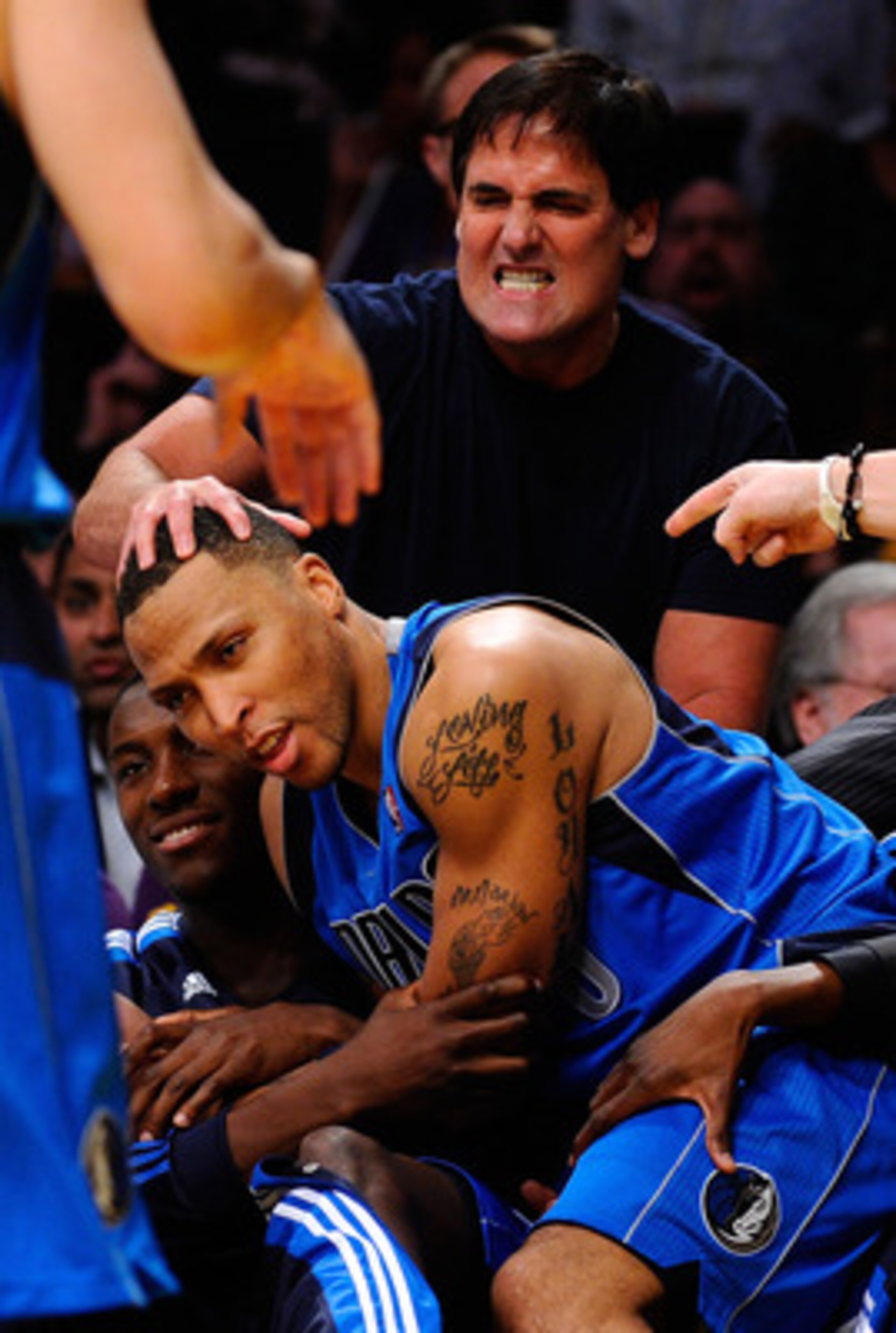 LOS ANGELES, CA - MAY 04:  Owner Mark Cuban of the Dallas Mavericks rubs the head of Shawn Marion #0 of the Dallas Mavericks as he falls into the bench as the Mavericks take on the Los Angeles Lakers in Game Two of the Western Conference Semifinals in the