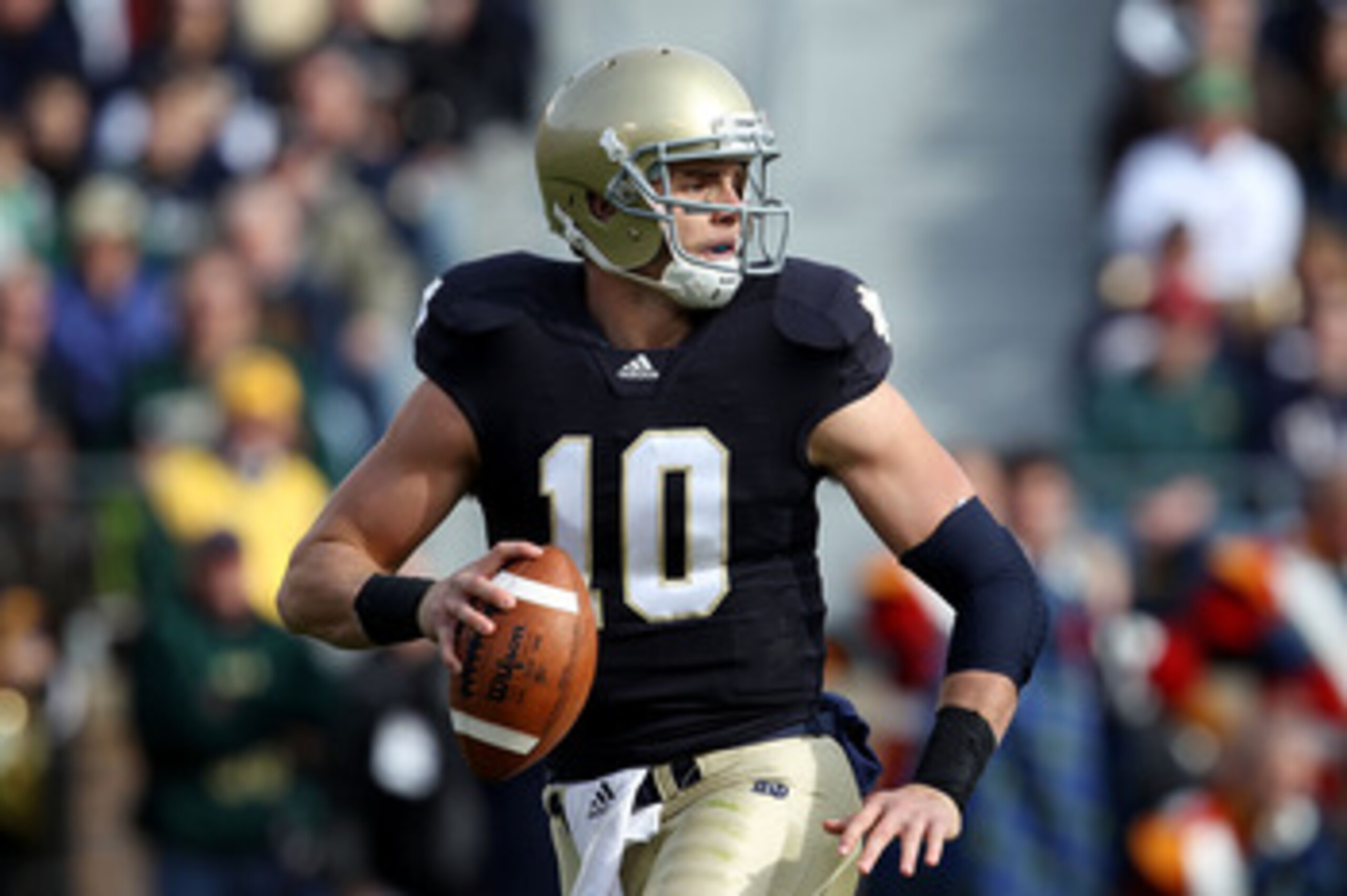 SOUTH BEND, IN - OCTOBER 30: Dayne Crist #10 of the Notre Dame Fighting Irish looks for a receiver against the Tulsa Golden Hurricane at Notre Dame Stadium on October 30, 2010 in South Bend, Indiana. Tulsa defeated Notre Dame 28-27. (Photo by Jonathan Dan