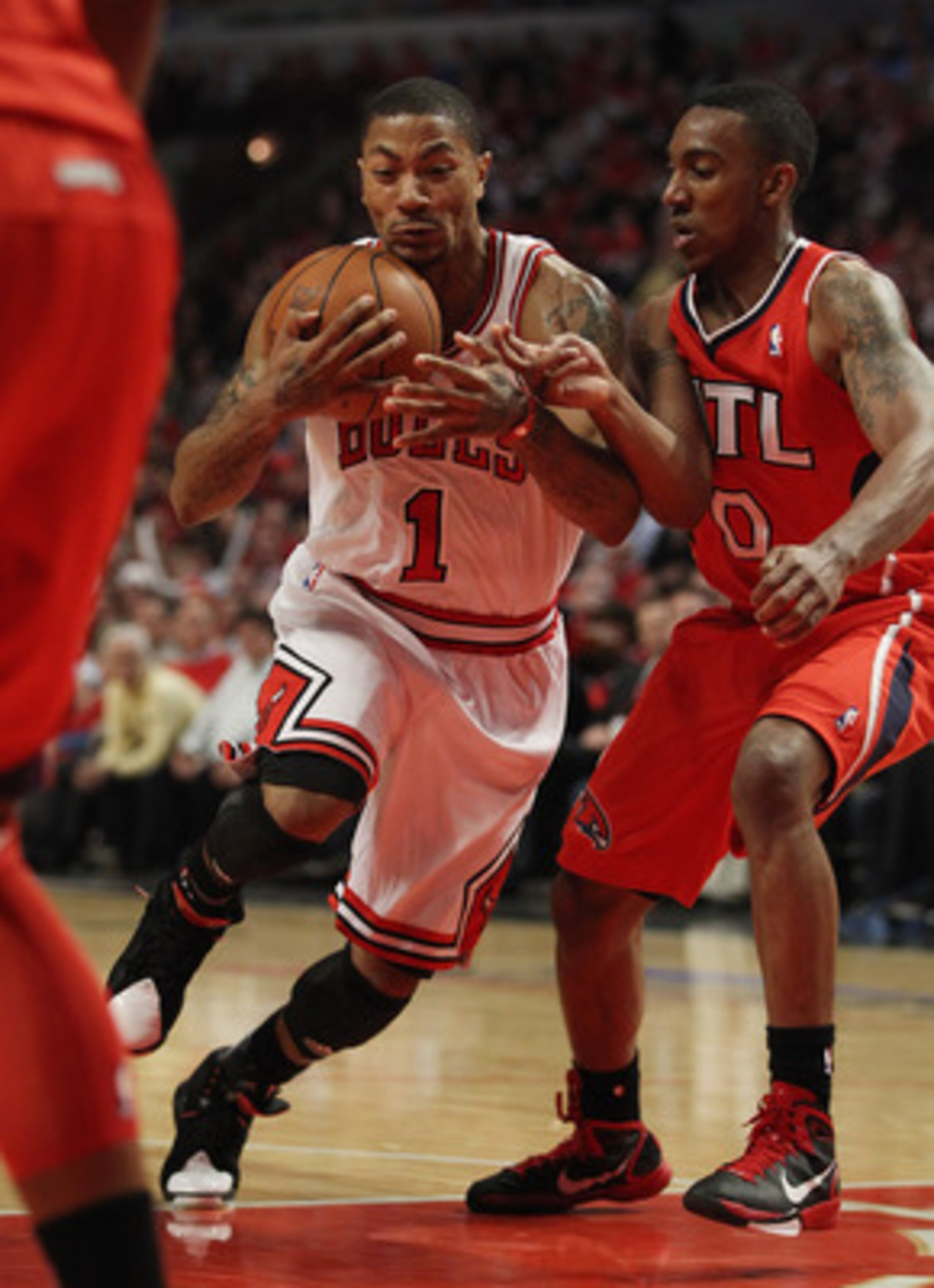CHICAGO, IL - MAY 04: Derrick Rose #1 of the Chicago Bulls hangs on to the ball as he moves past Jeff Teague #0 of the Atlanta Hawks in Game Two of the Eastern Conference Semifinals in the 2011 NBA Playoffs at the United Center on May 4, 2011 in Chicago,